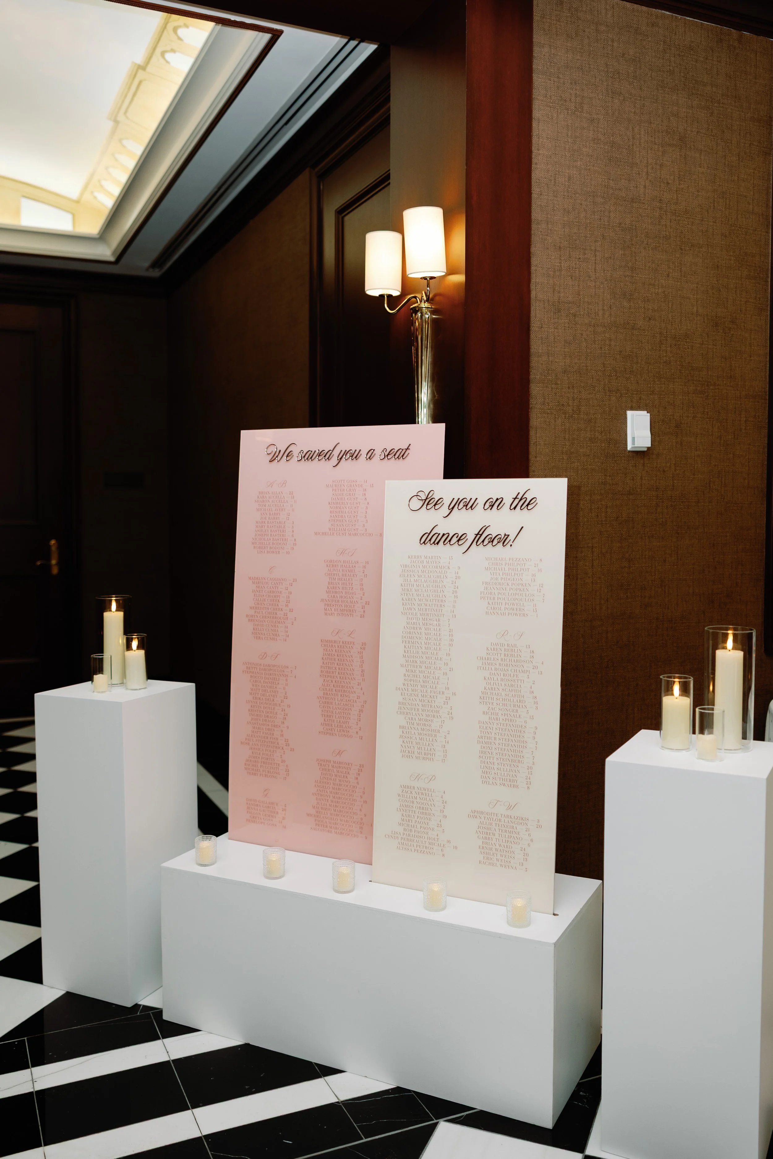 Blush and cream acrylic seating chart with LED candles at the Colonnade Hotel in Boston, mA