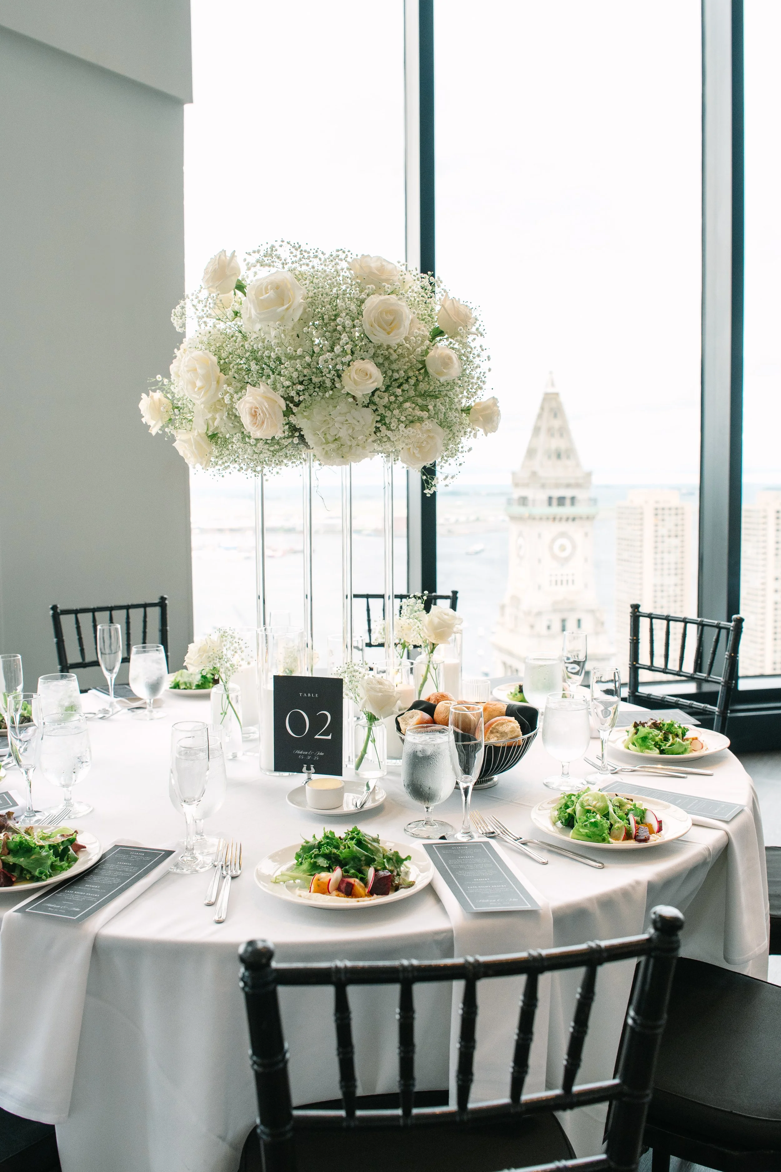 Elegant, custom black and white table numbers with silver holders at the iconic State Room in Boston, MA