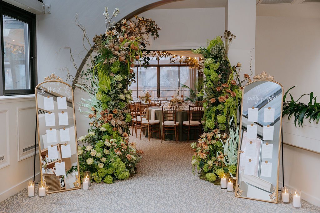 Vintage ornate gold mirror wedding seating chart featuring white hand-lettered calligraphy and card stock and wax seal - Bostonian Hotel