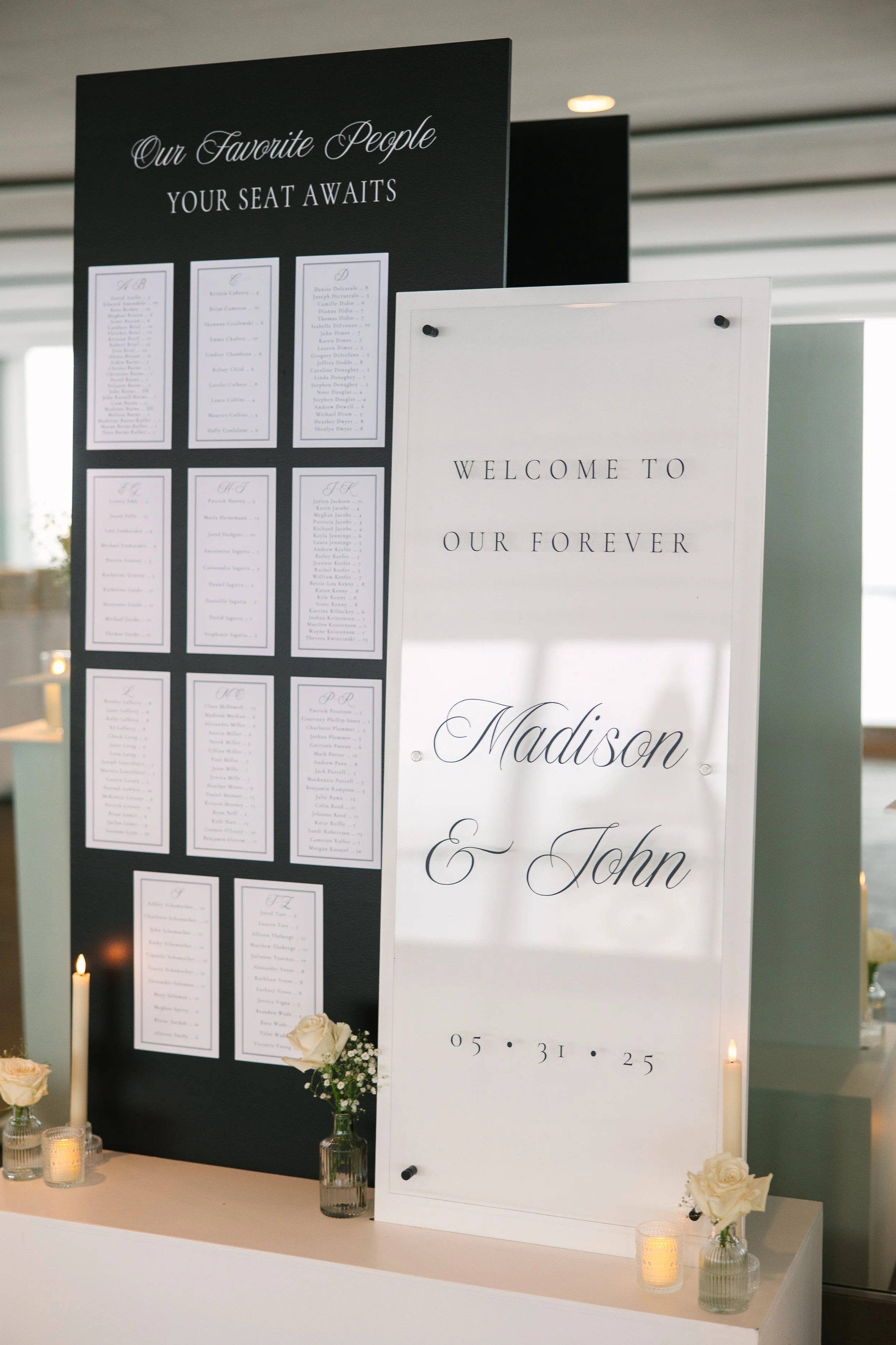 Personalized black and white wedding welcome sign and seating chart display featuring a modern elegant layout at a Boston wedding reception - State Room