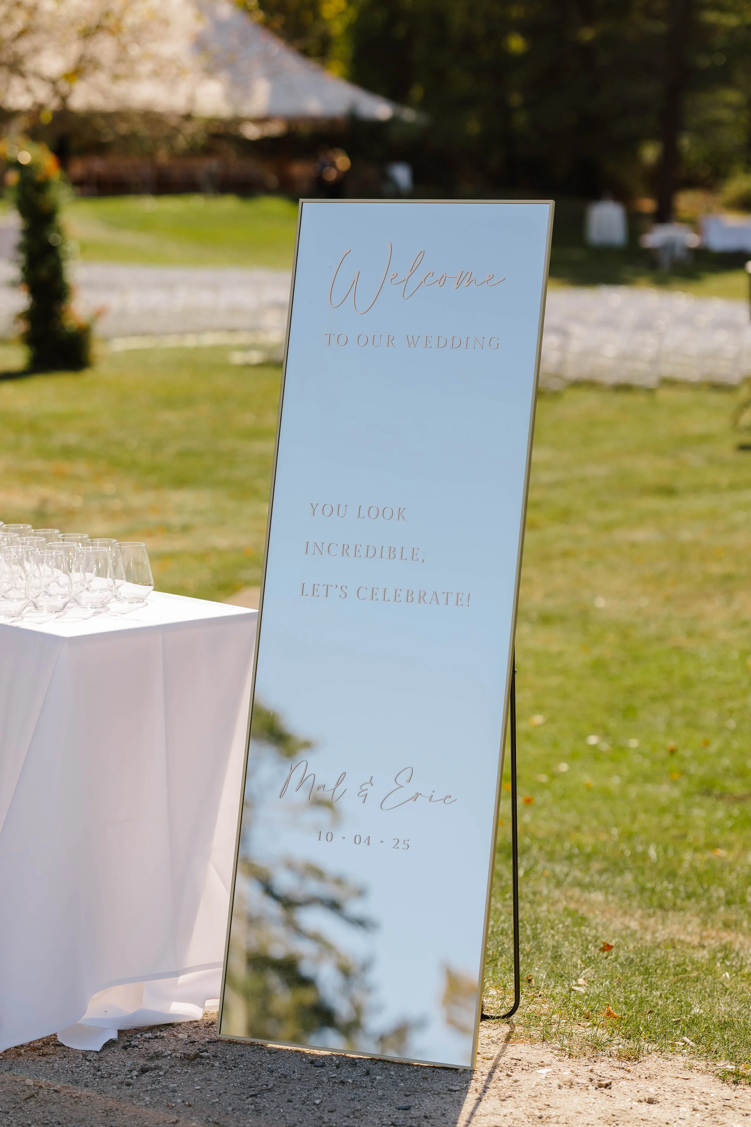 Modern gold mirror wedding selfie welcome sign with white vinyl lettering for a coastal wedding at the Inn at Diamond Cove