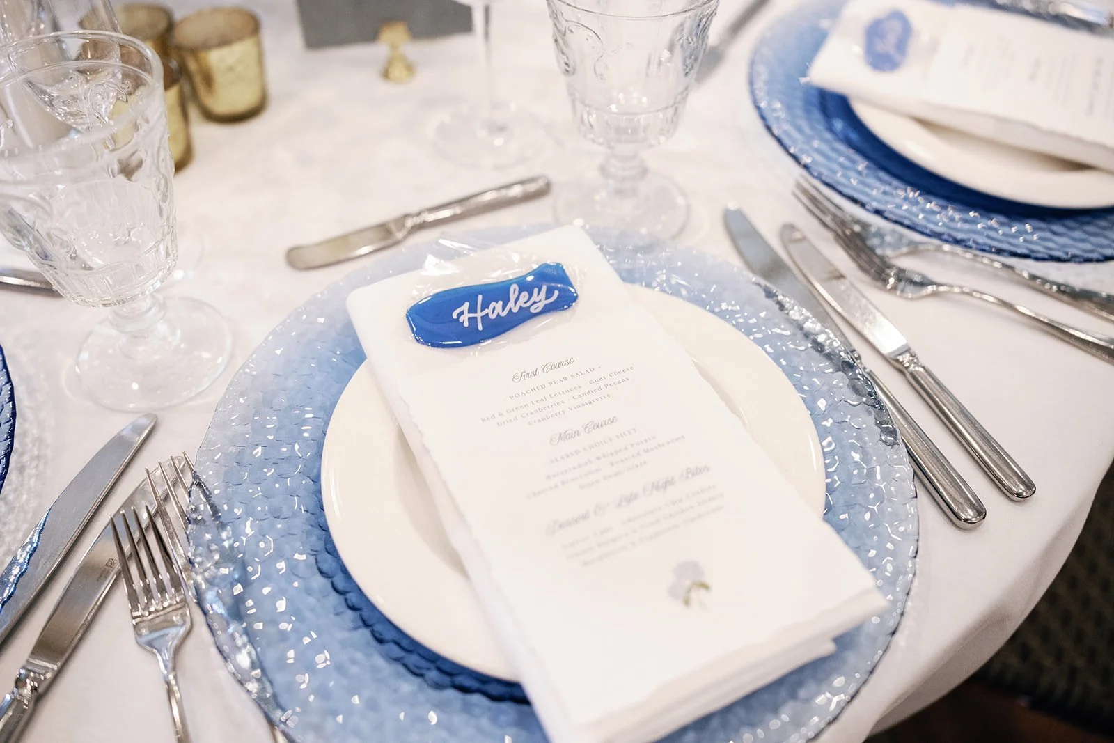 Elegant table setting with sea glass calligraphy place cards and deckled edge dinner menus for a wedding at the Nantucket Hotel & Resort in Nantucket, MA