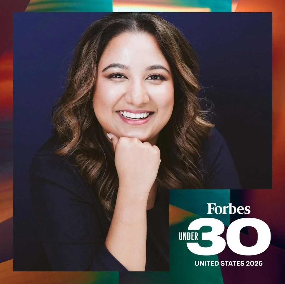 Smiling young woman with long, wavy hair, wearing a dark top, with text overlaid that says "Forbes Under 30 United States 2026."