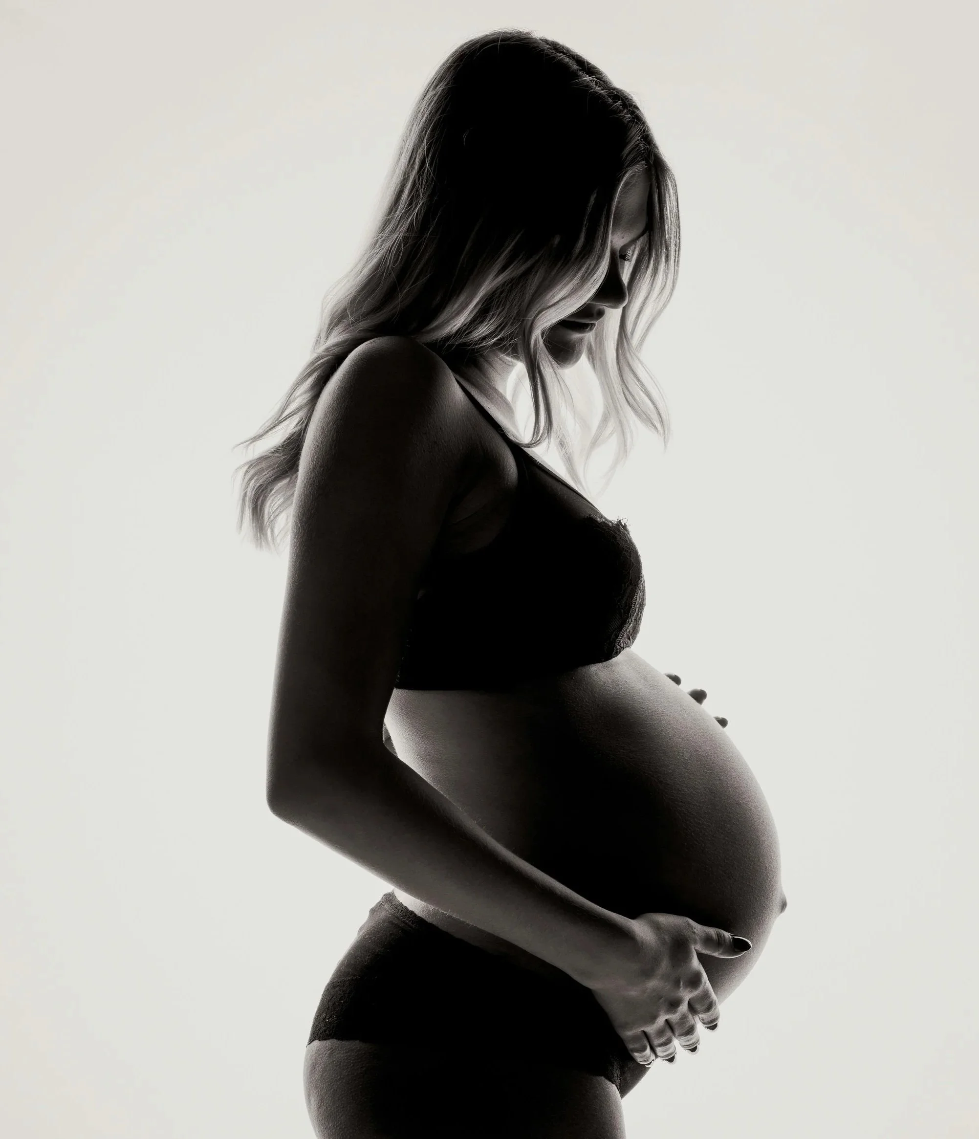 Silhouette of pregnant woman in black and white