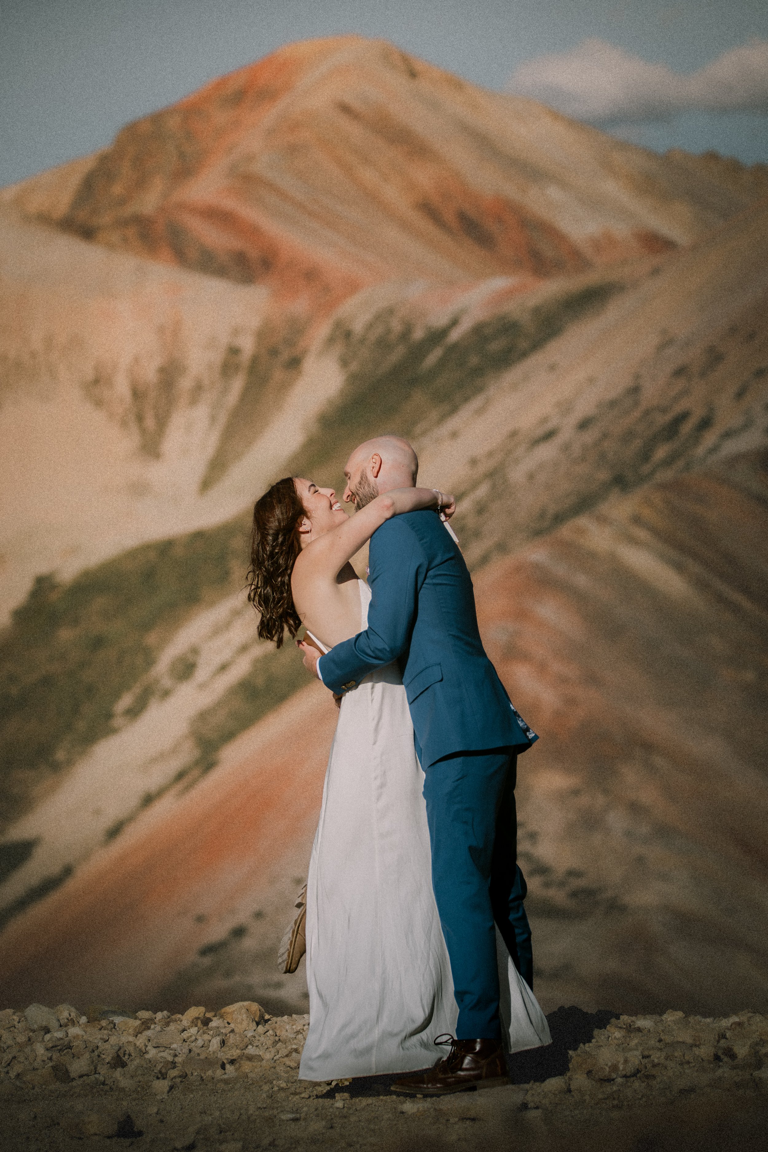 A couple eloping on Corkscrew Pass in the San Juan Mountains of Silverton, Colorado with the Red Mountains in the background.