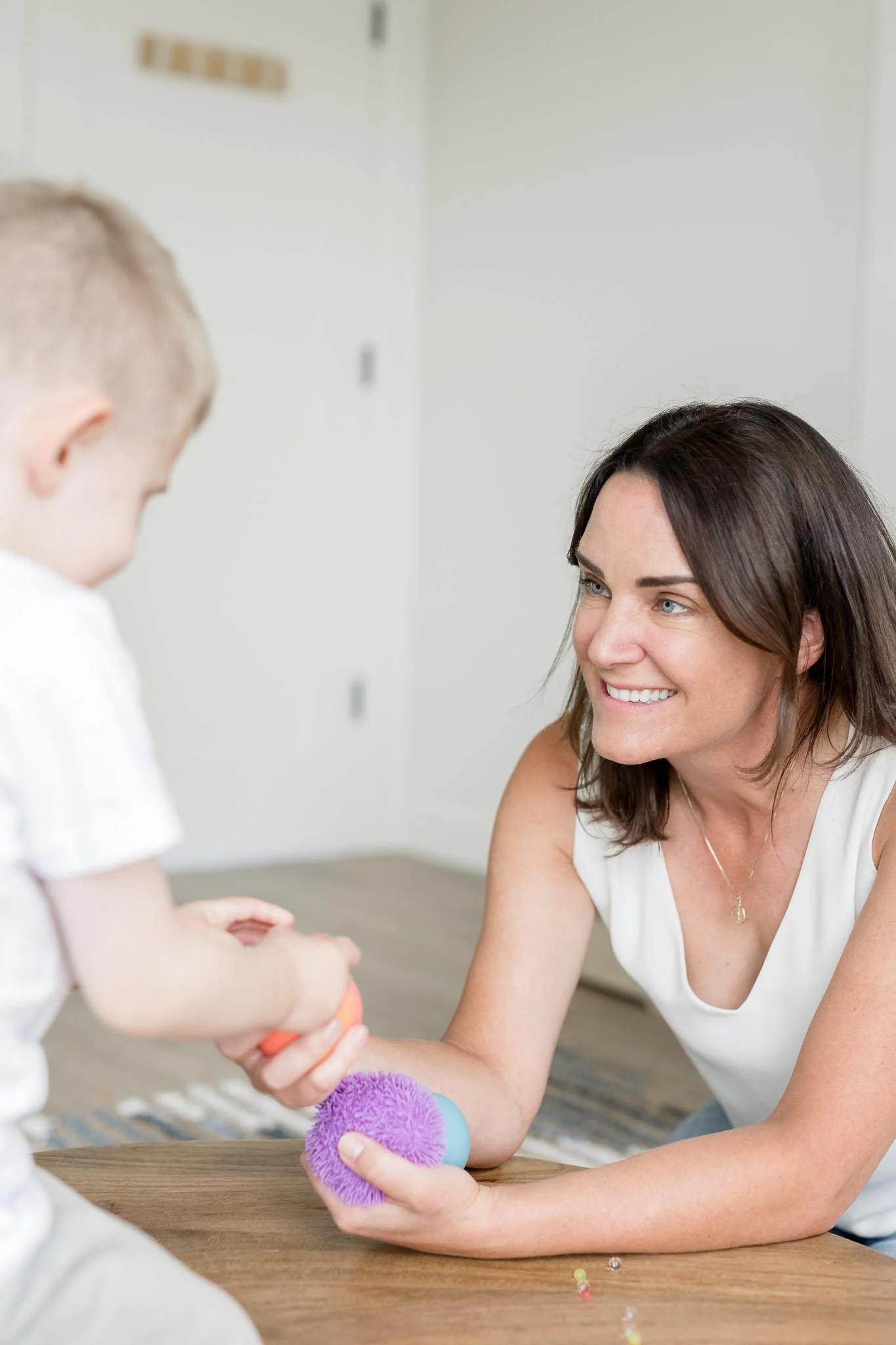 Play-based therapy session in Calgary with a child and psychologist using sensory play to build connection and emotional regulation.