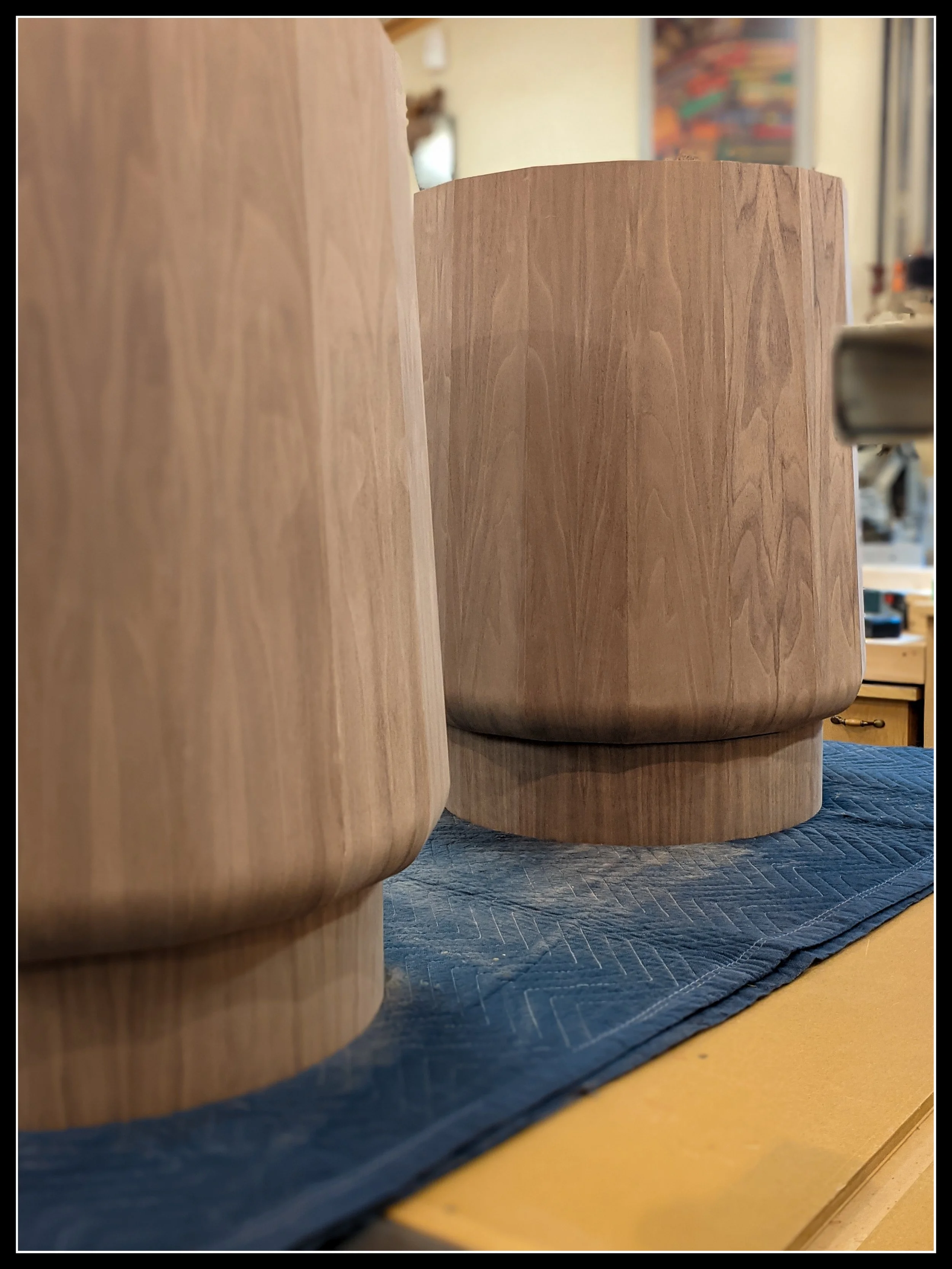 Walnut stave‑built table pedestals for a 12‑foot oval table, veneered and glued up into curved heirloom hardwood forms.
