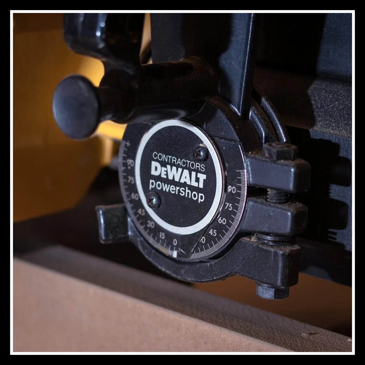 Close‑up of DeWalt 5800 radial arm saw motor assembly with cast‑iron housing and contractor‑grade angle adjustment dial.