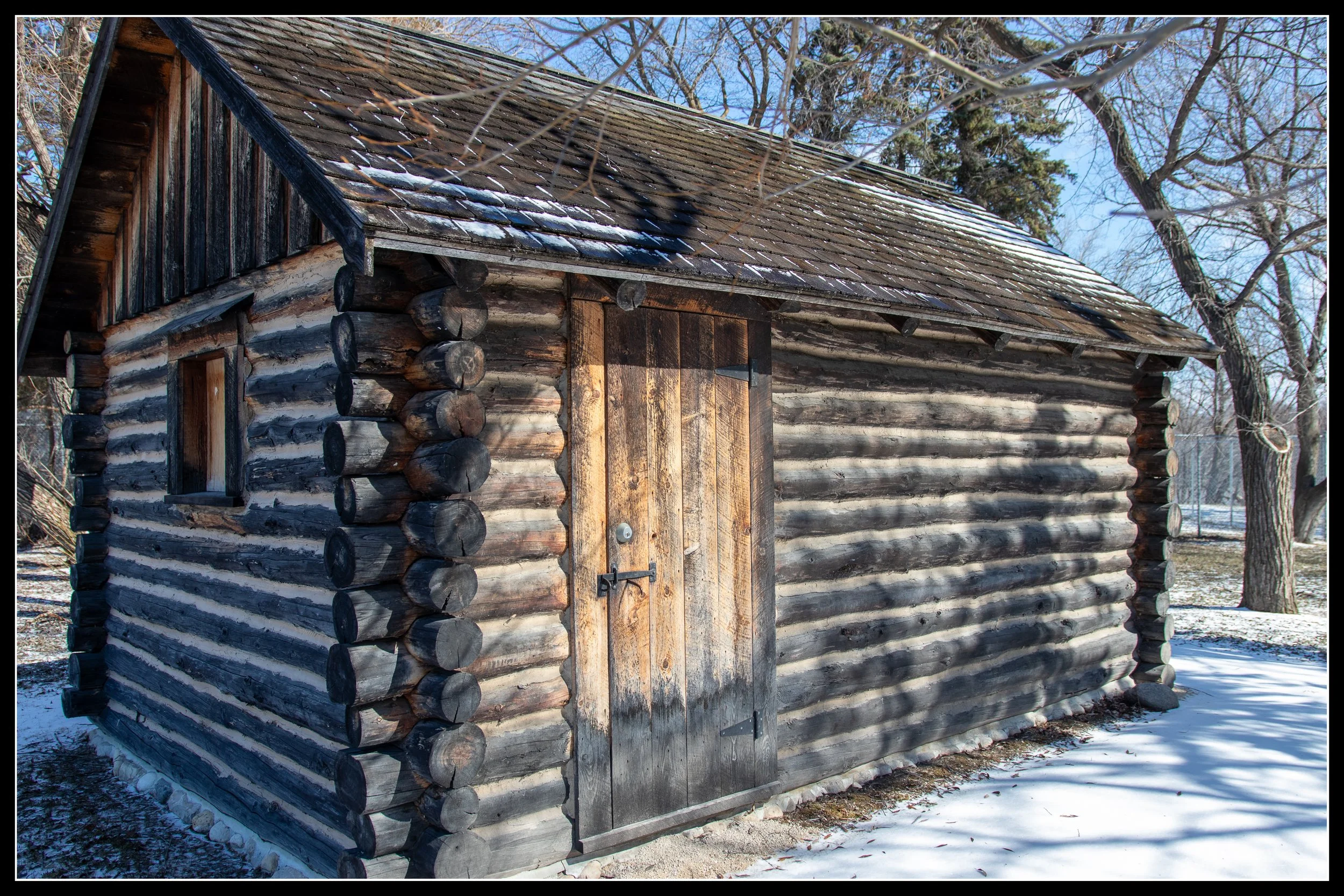 1871 Turenne House log cabin from St. Norbert, built from local hardwoods and preserved today at a museum after surviving decades of river flooding.