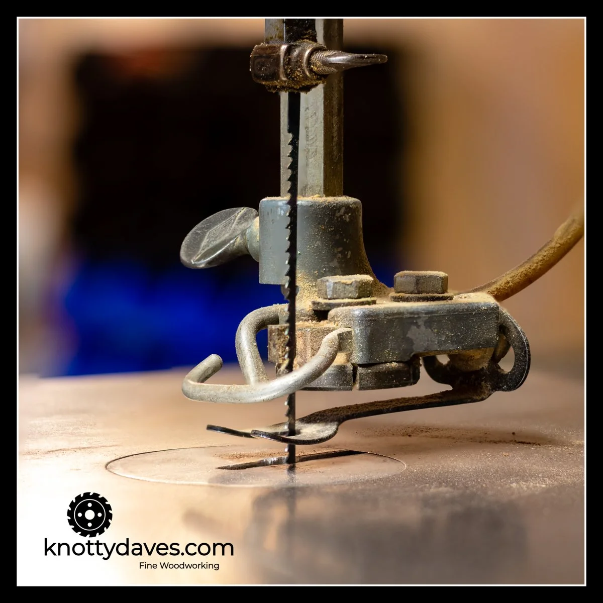 Close‑up of the cast‑iron foot of a 1950s Delta 30‑inch scroll saw, showing the heavy frame and smooth running mechanism used by the woodworker during his youth.