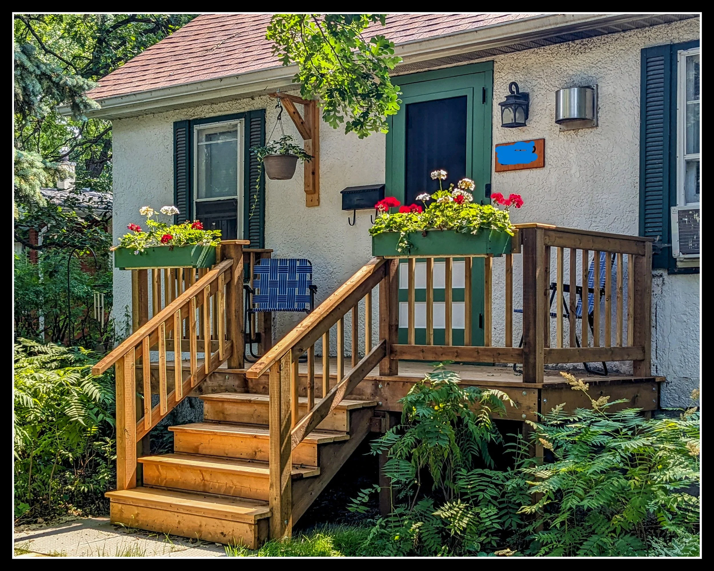 Front deck of an old prairie house, symbolizing the 1880s home restored after decades of storms, moves, and Manitoba winters.