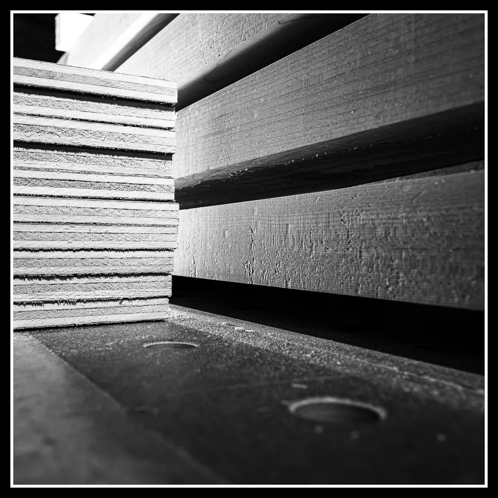 Stacked wooden boards on the bench, symbolizing the future being built at Knotty Dave’s.