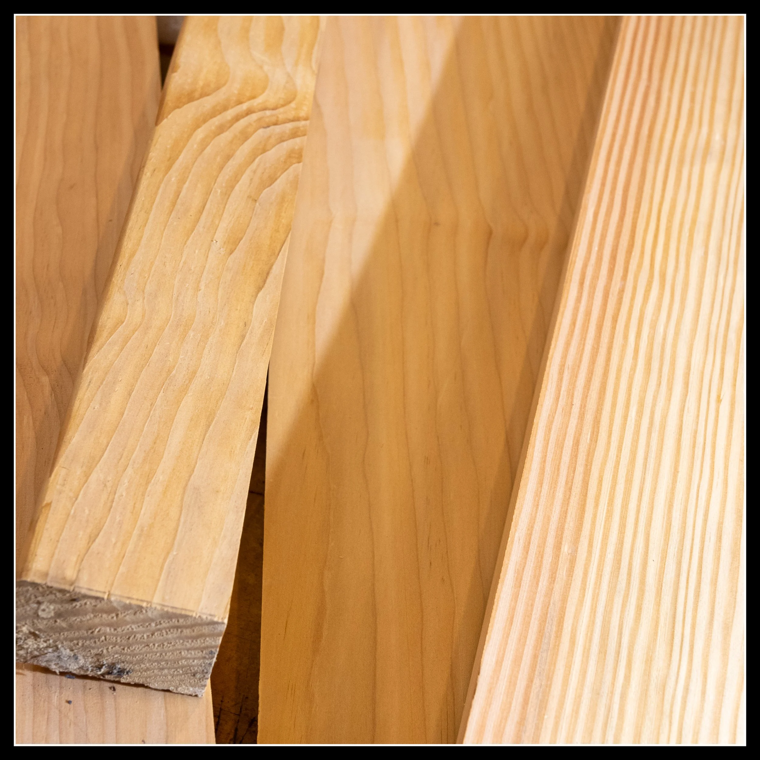 Raw Douglas Fir boards showing straight grain, light colour, and classic fir growth‑ring pattern used in mid‑century woodworking and Prairie millwork.