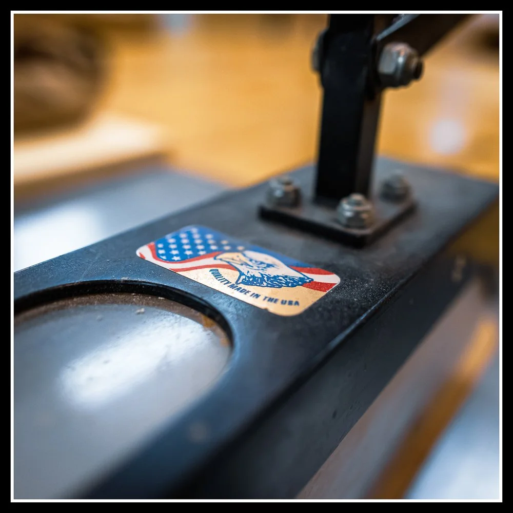 Biesemeyer overhead table saw guard with quick‑release design, showing heavy‑duty steel construction and ideal setup for sheet goods and jig work.