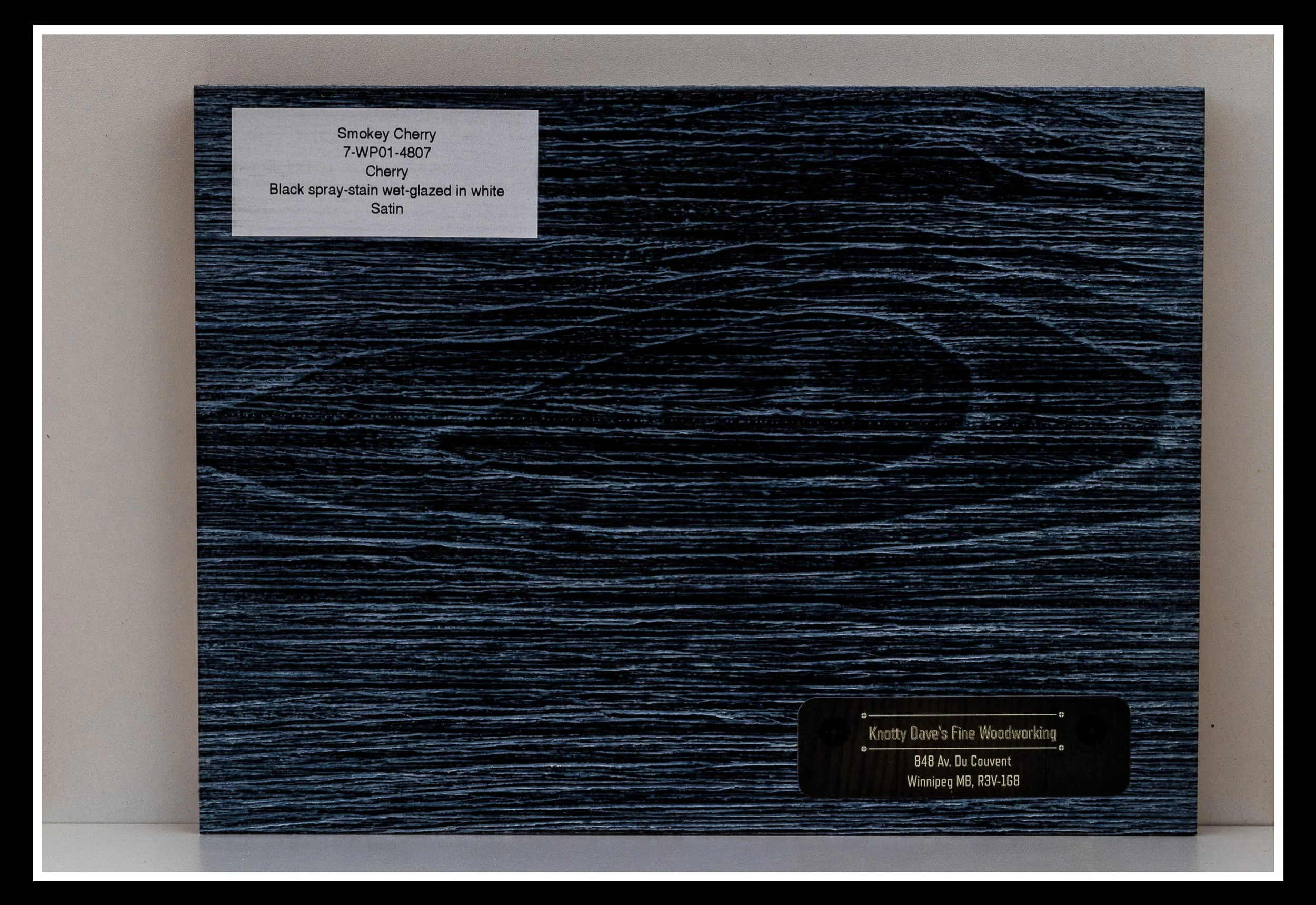 Close‑up of cherry wood grain with deep brushing, black stain, white glaze, textured grain, and a satin 2K poly finish.