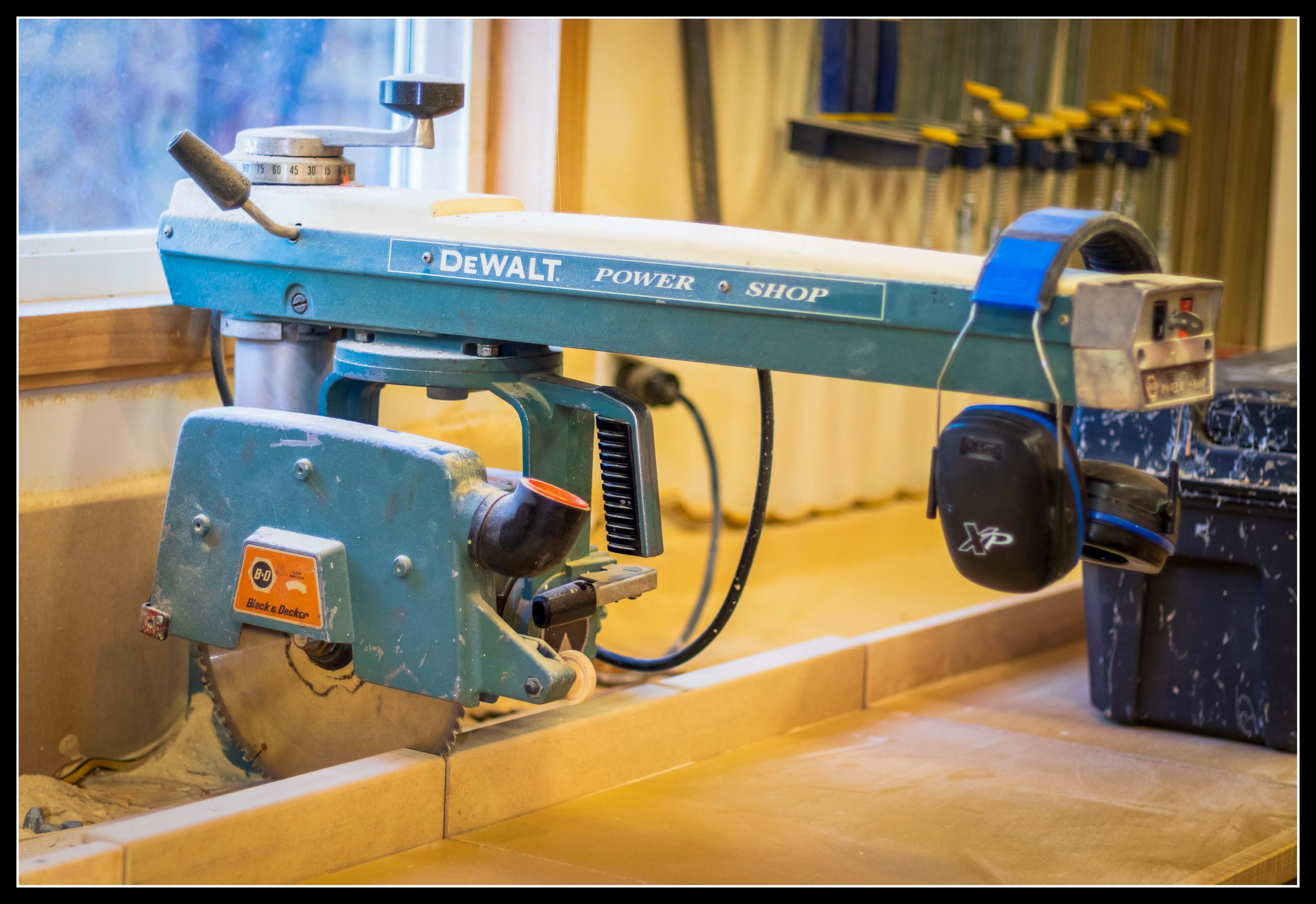 1960’s DeWalt 10-inch homeowner radial arm saw with minimal cast‑iron arm, showing lightweight construction typical of home‑use models.