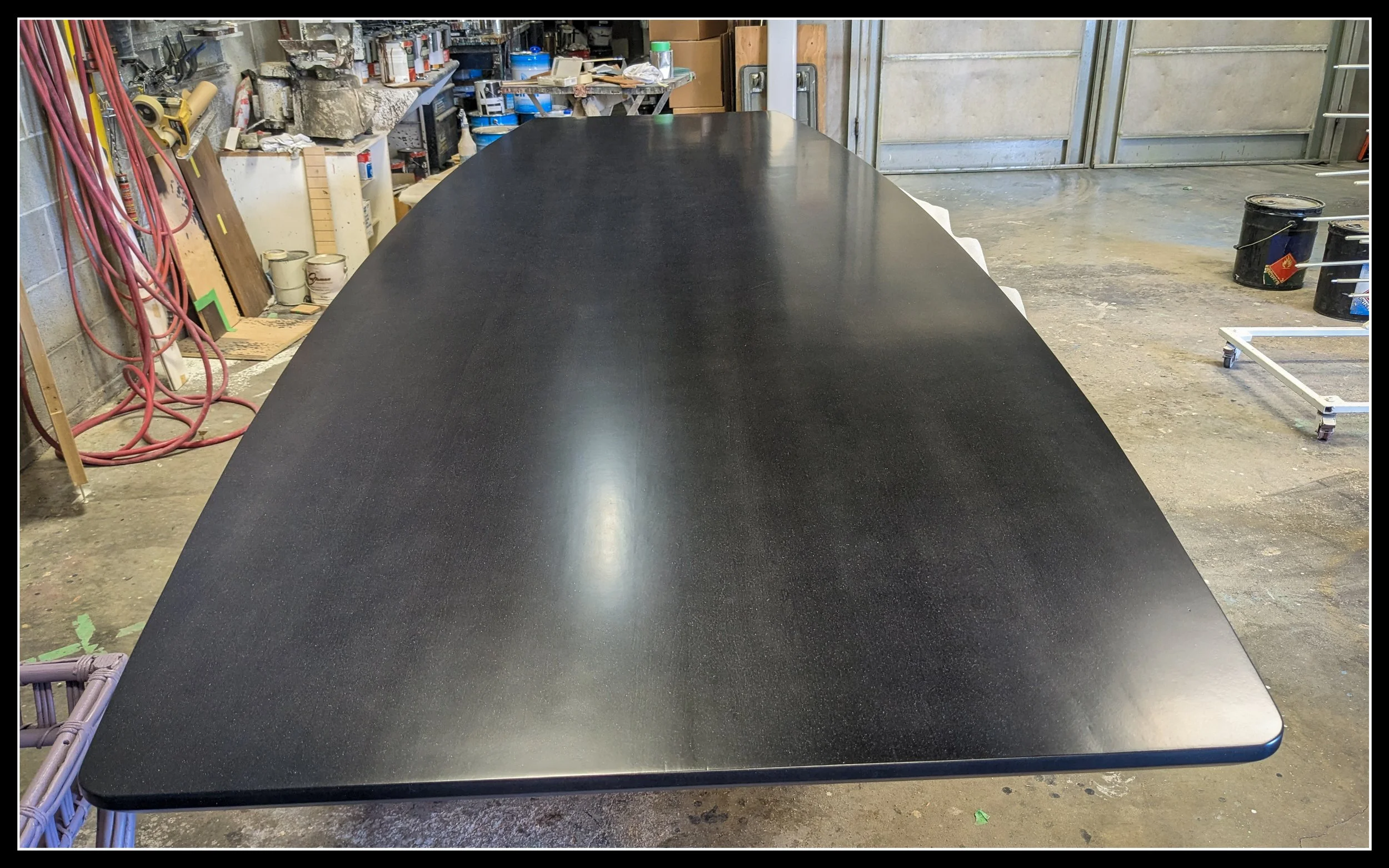Polished maple table with a smooth reflective finish showing refined surface texture.  File Name: