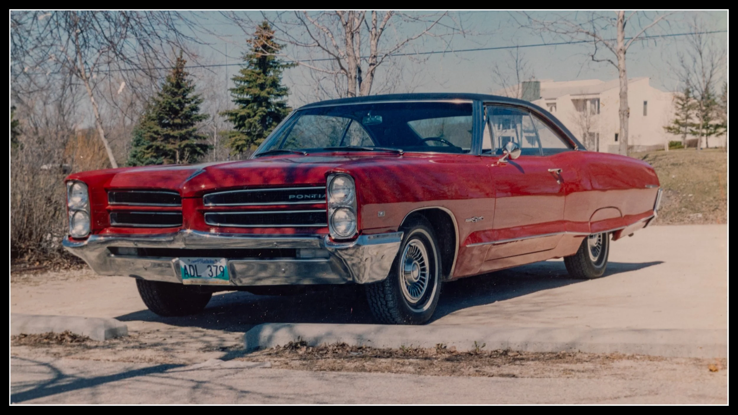 1966 Pontiac Parisienne Custom Sport, Canadian‑built model, restored red classic car with chrome trim and stacked headlights parked outdoors.