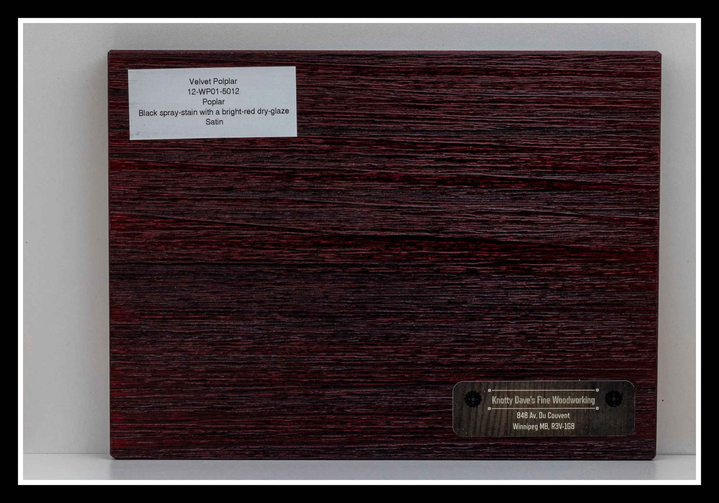 Close‑up of velvet poplar wood grain with deep scraping, velvety red stain, dark glaze, and a 2K poly finish.