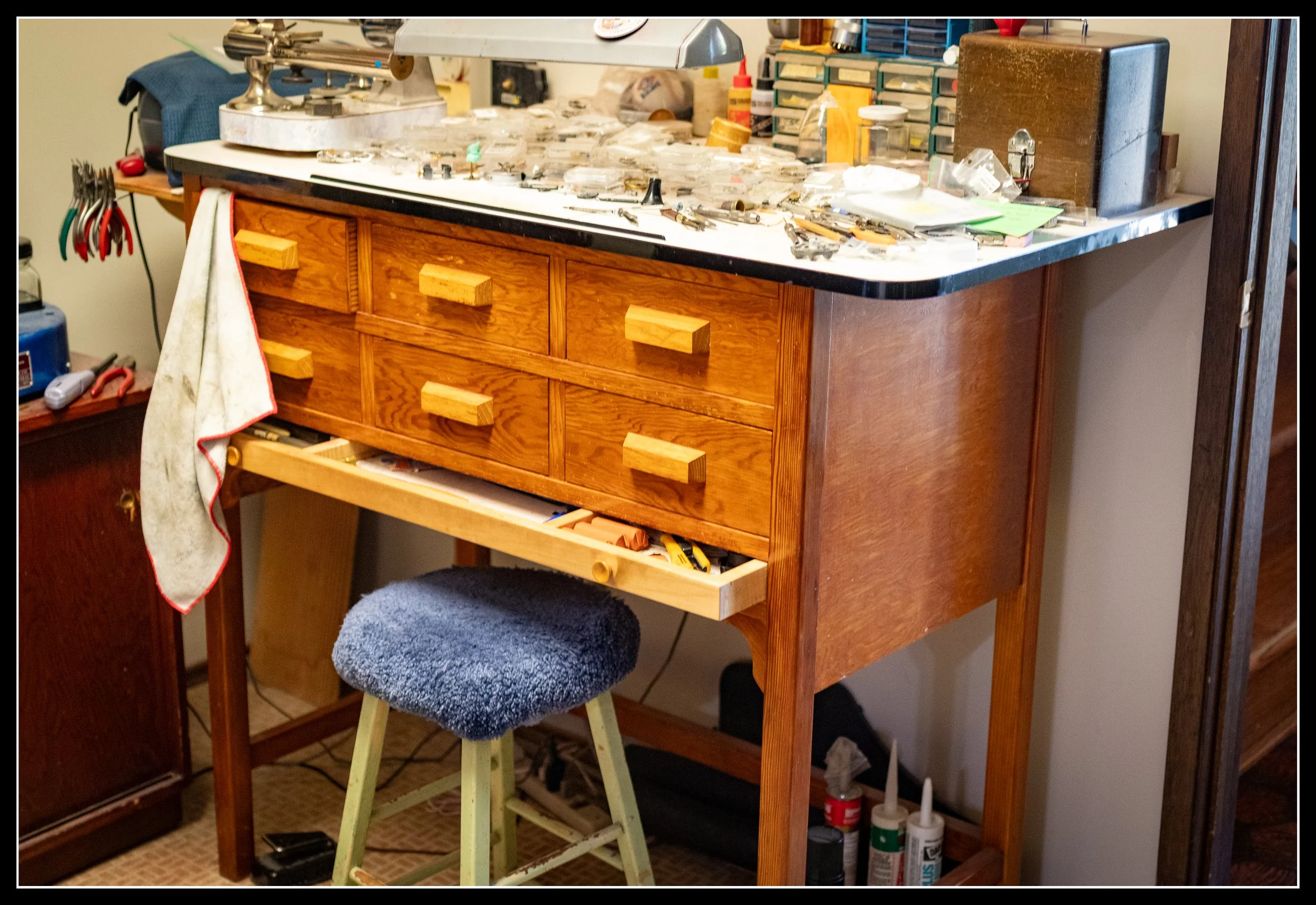 Vintage Douglas Fir watchmaker’s bench built in the late 1950s, with solid fir framing, fir plywood, plastic laminate top, and a replaced poplar drawer, showing classic mid‑century craftsmanship.