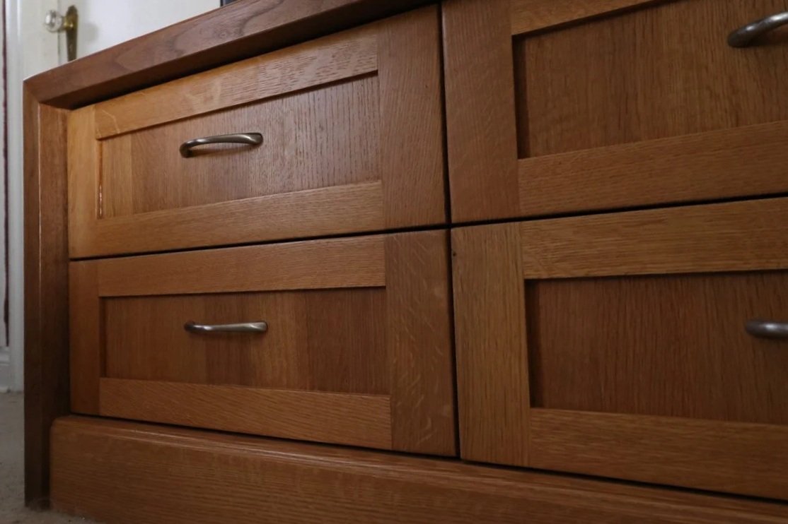 White oak cabinet with a light stain and clearcoat, paired with a dark walnut countertop, showing clean joinery, warm grain, and natural contrast between the two hardwoods.