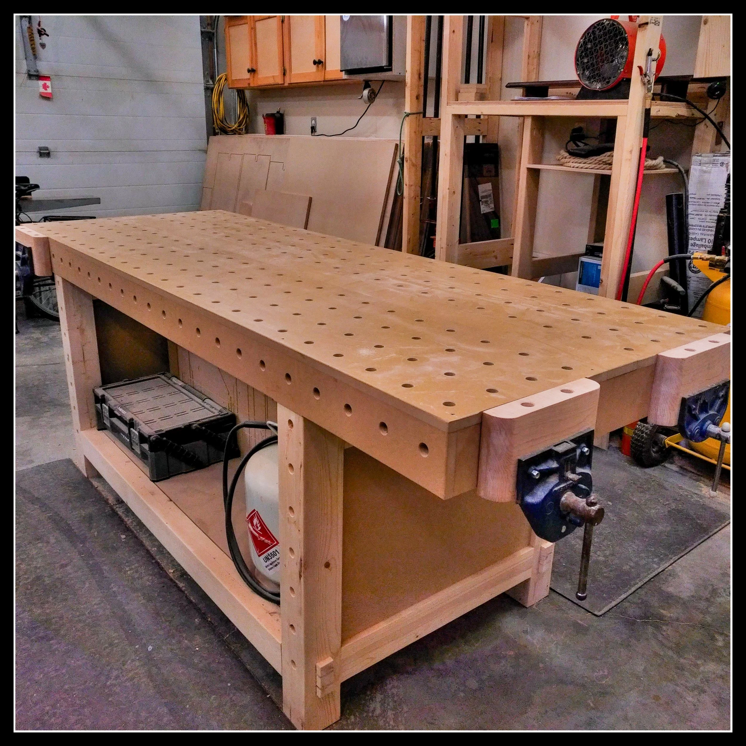 MFT woodworking bench with perfectly aligned 90‑degree holes, clamps, and vises, representing precision and repeatable workflow in a small shop.