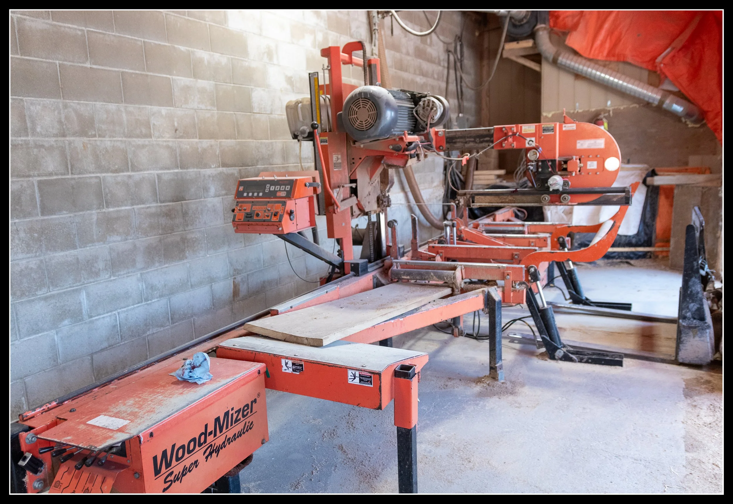 Electric Wood‑Mizer sawmill used for milling urban elm, where hidden metal often destroys blades and slows production.