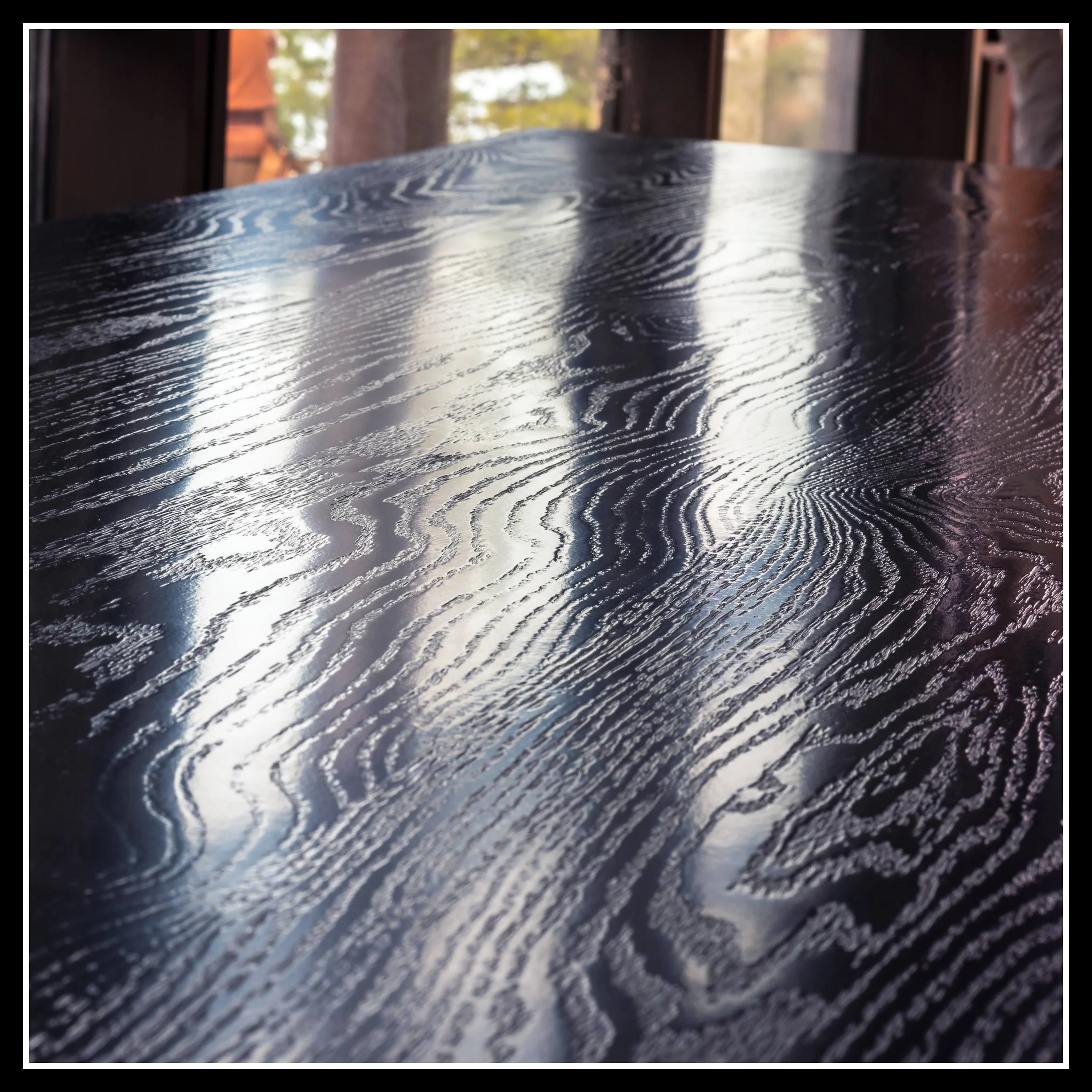 Red oak table showing bold texture from soft spring growth and hard summer growth in the grain.
