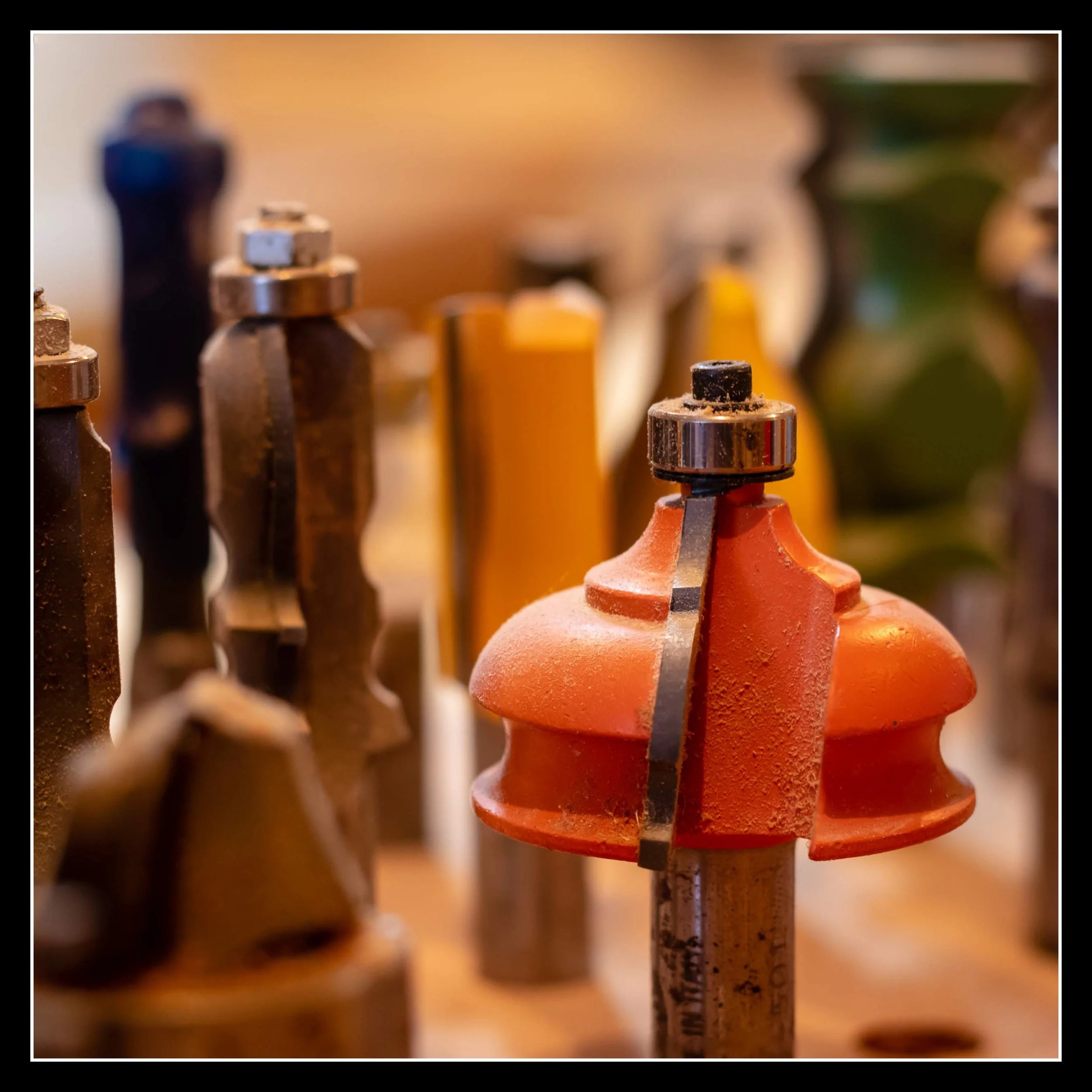 Assorted woodworking router bits showing different edge‑profile shapes used to control light and shadow.