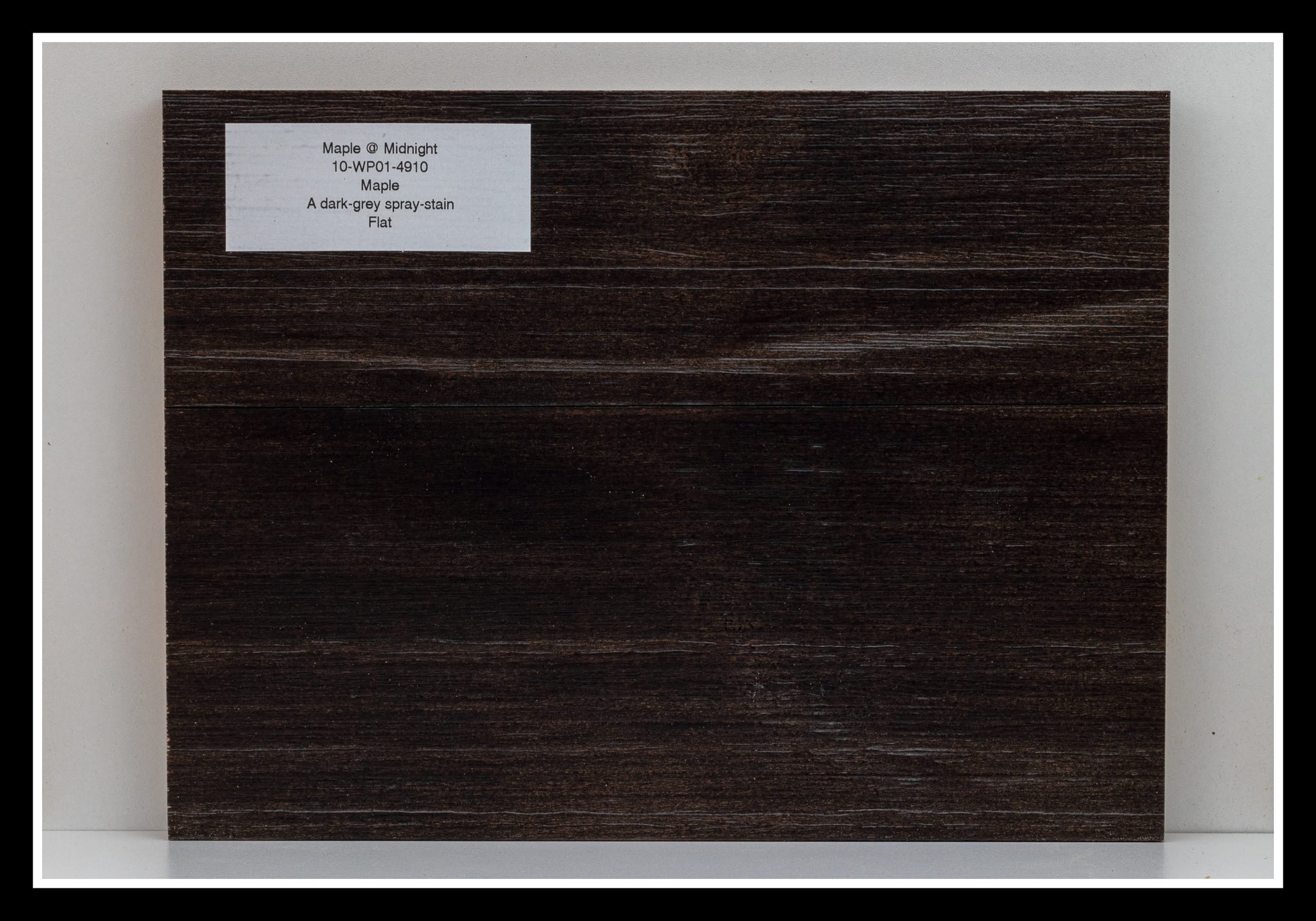 Close‑up of hard maple wood grain with deep brushing, dark stain, soft glaze, textured grain, and a satin 2K poly finish.