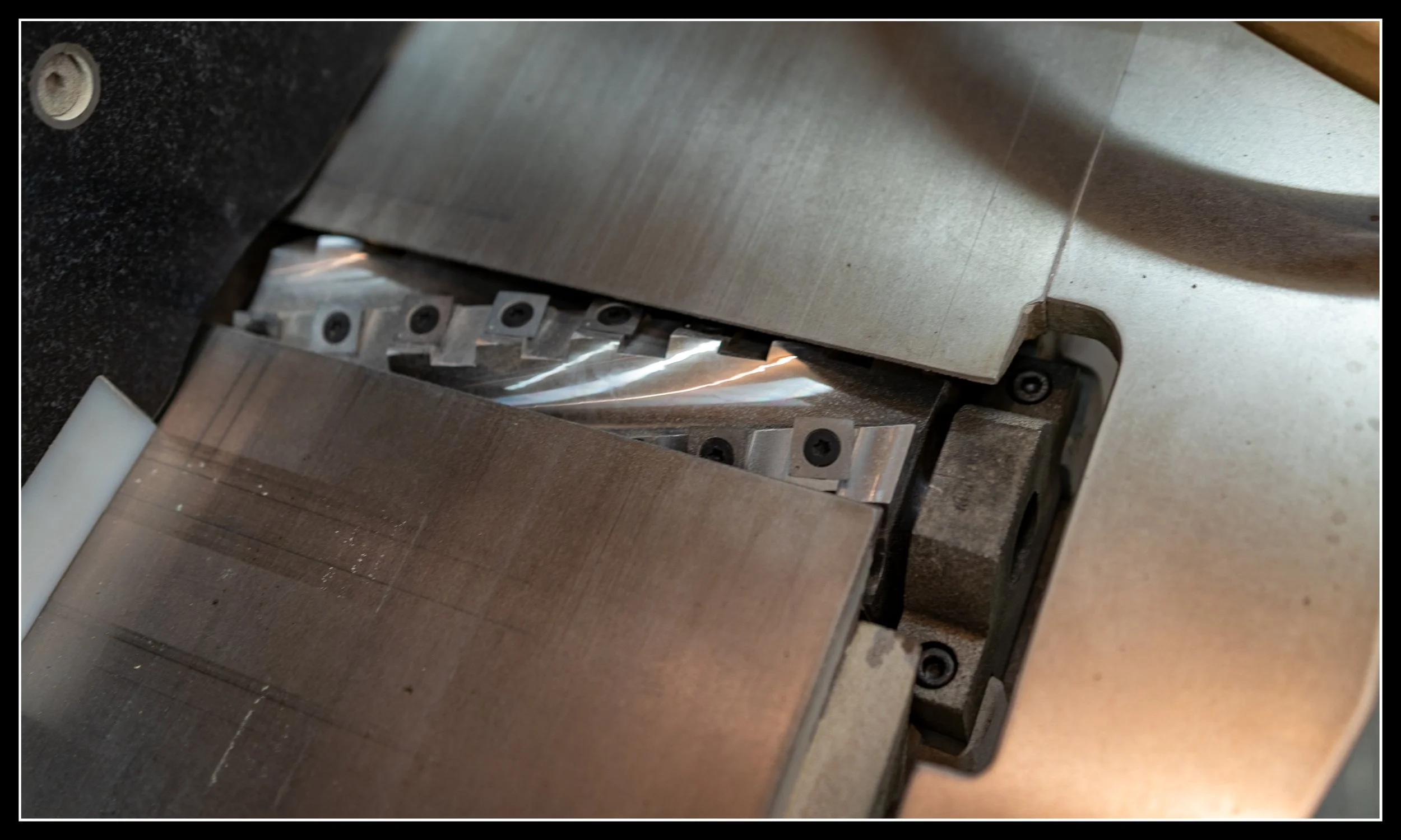 Close‑up of newly installed carbide helical cutterhead inside a Steel City 8‑inch jointer, showing precision inserts and upgraded milling capability.