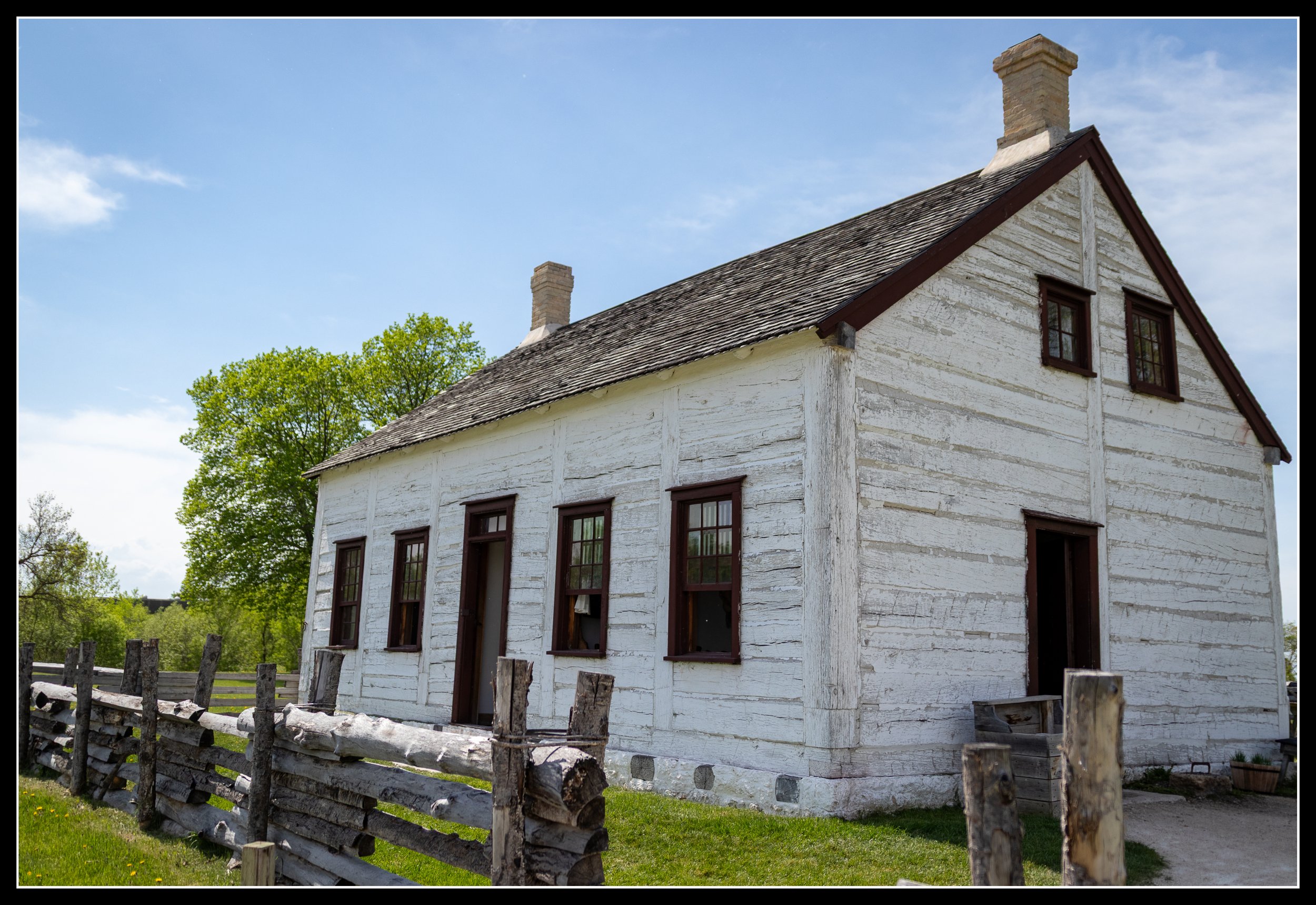 A historic timber‑framed residence at Lower Fort Garry built from local Red River wood, showing hand‑cut planks and early 19th‑century post‑and‑frame construction used at the southern end of the York boat route.