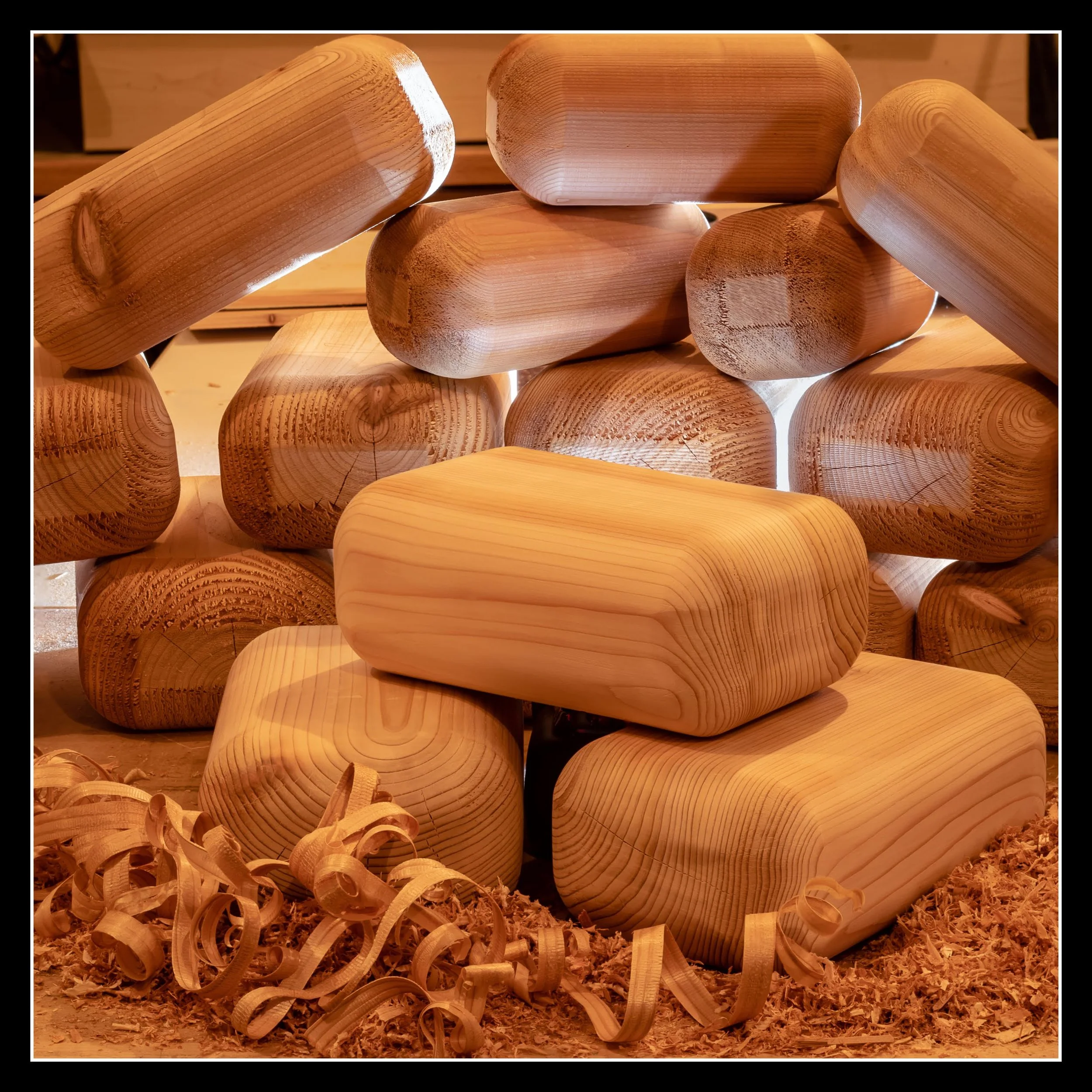 A stack of yoga cedar blocks, arranged on a bed of wood shavings.