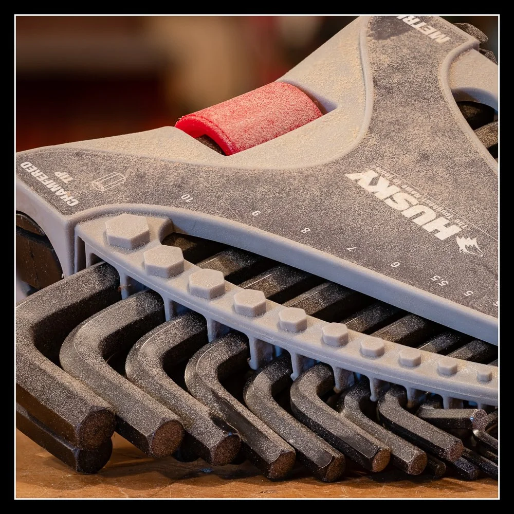 Set of Husky metric and imperial Allen keys in a gray and red holder, showing the full range of hex sizes with light workshop dust from regular use.