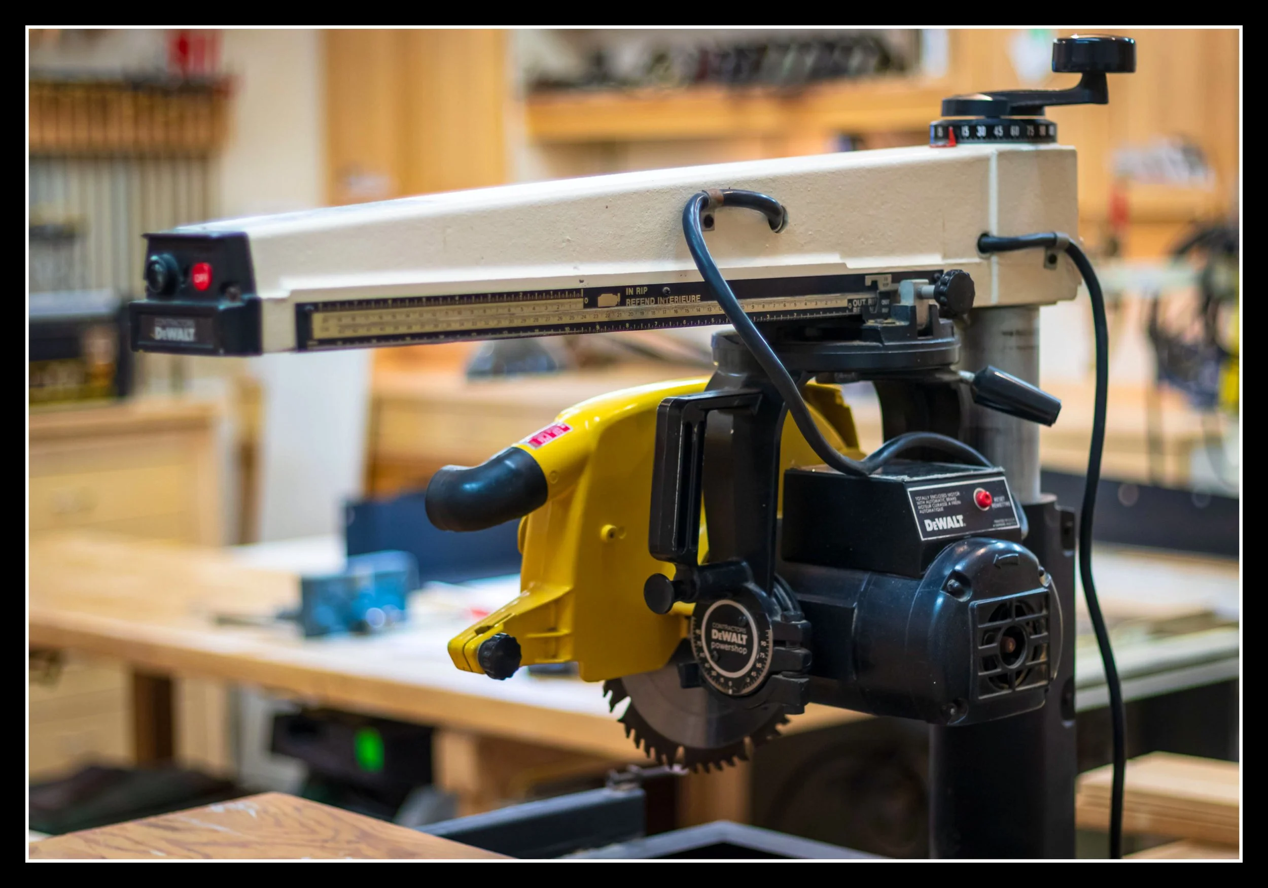 Canadian‑made DeWalt 5800 12-inch radial arm saw from the mid‑1980s with heavy cast‑iron arm, induction motor, and workshop setup for precision cross‑cutting.