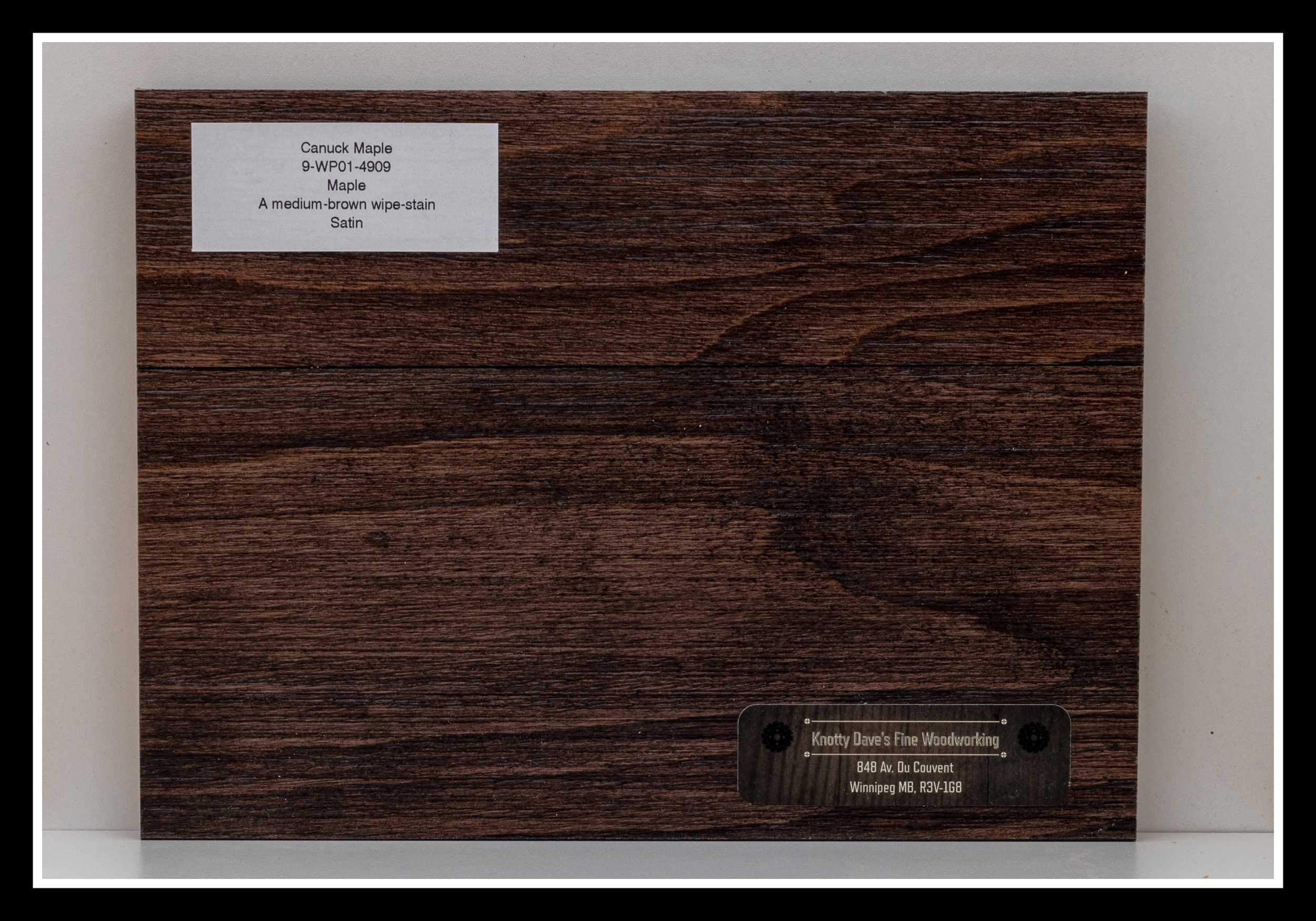 Close‑up of hard maple wood grain with brushed texture, warm brown stain, soft glaze, and a satin 2K poly finish.
