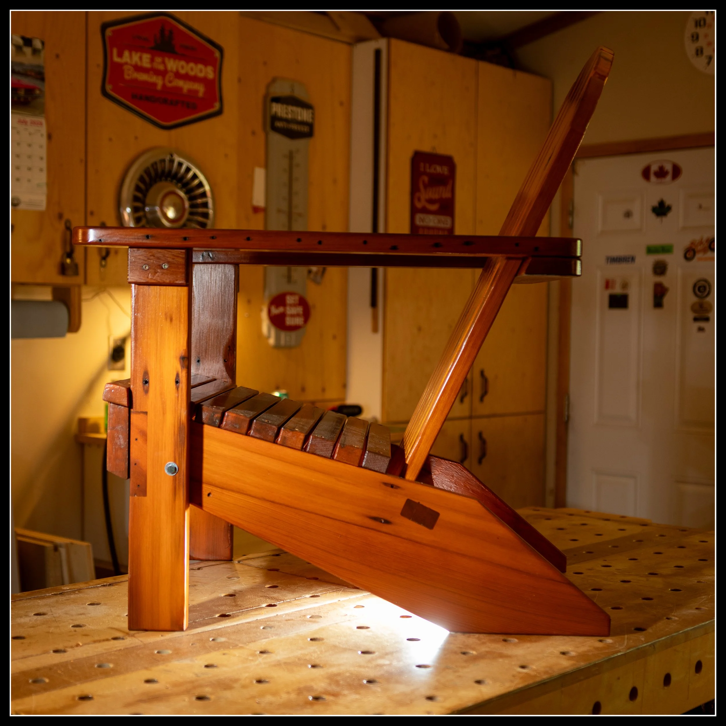 Side profile of Grandpa’s cedar deck chair with a wedged through‑tenon frame and a rich long‑oil finish, showing traditional joinery and warm heritage cedar grain.