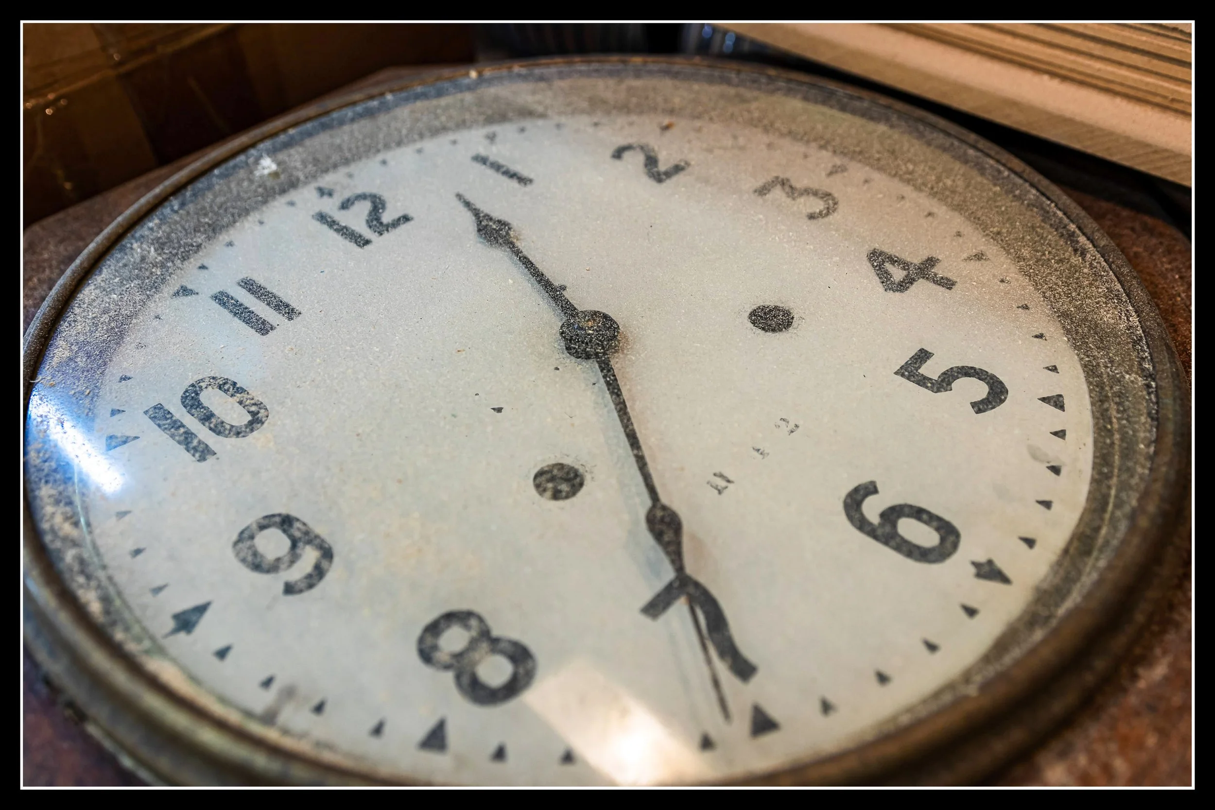 A worn 1895 Seth Thomas clock with an aged face and metal rim, symbolizing the passage of time and the enduring strength of old‑growth wood.