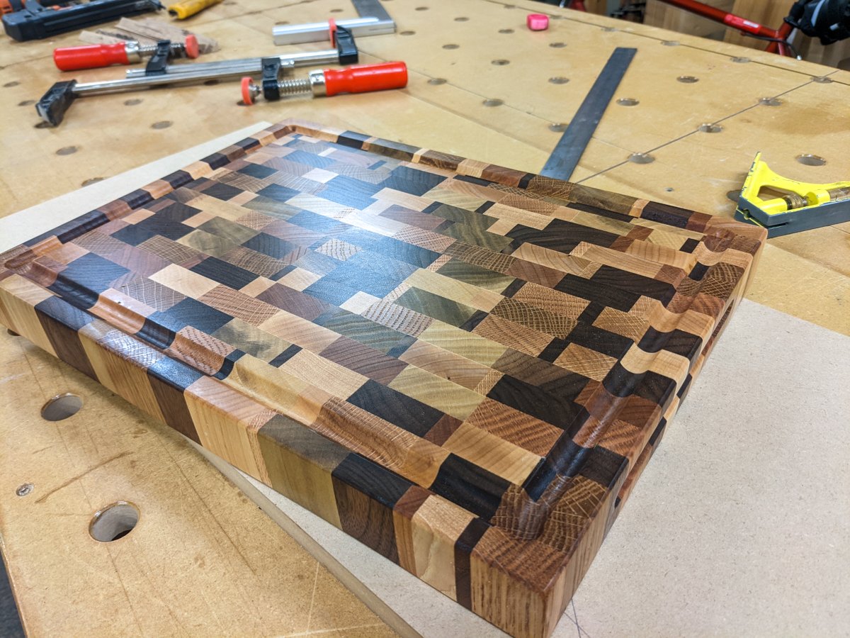 End grain cutting board made with multiple hard wood species.
