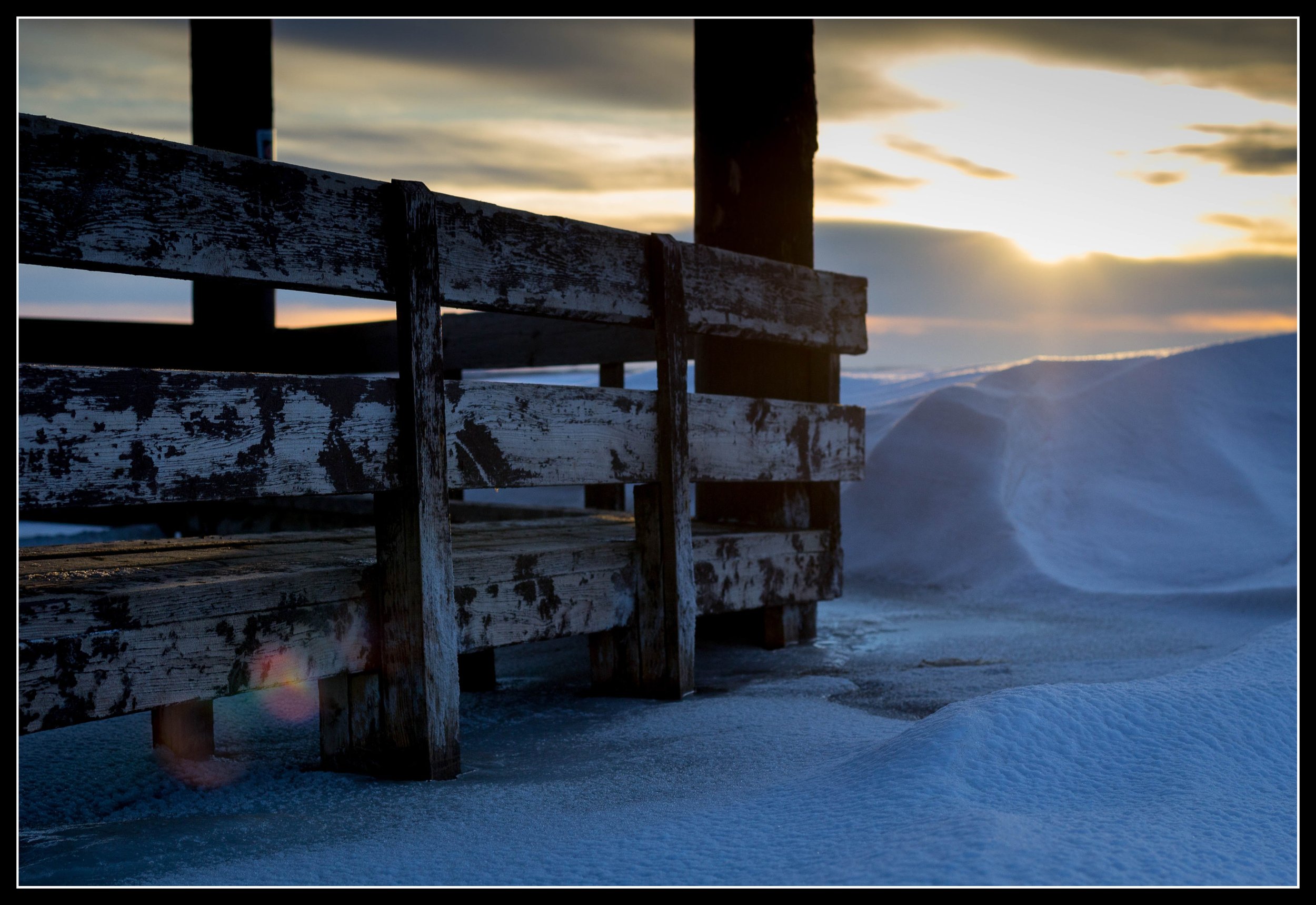Gazebo in Lake Manitou, Saskatchewan, frozen into high water and surrounded by March snowdrifts at sunrise.