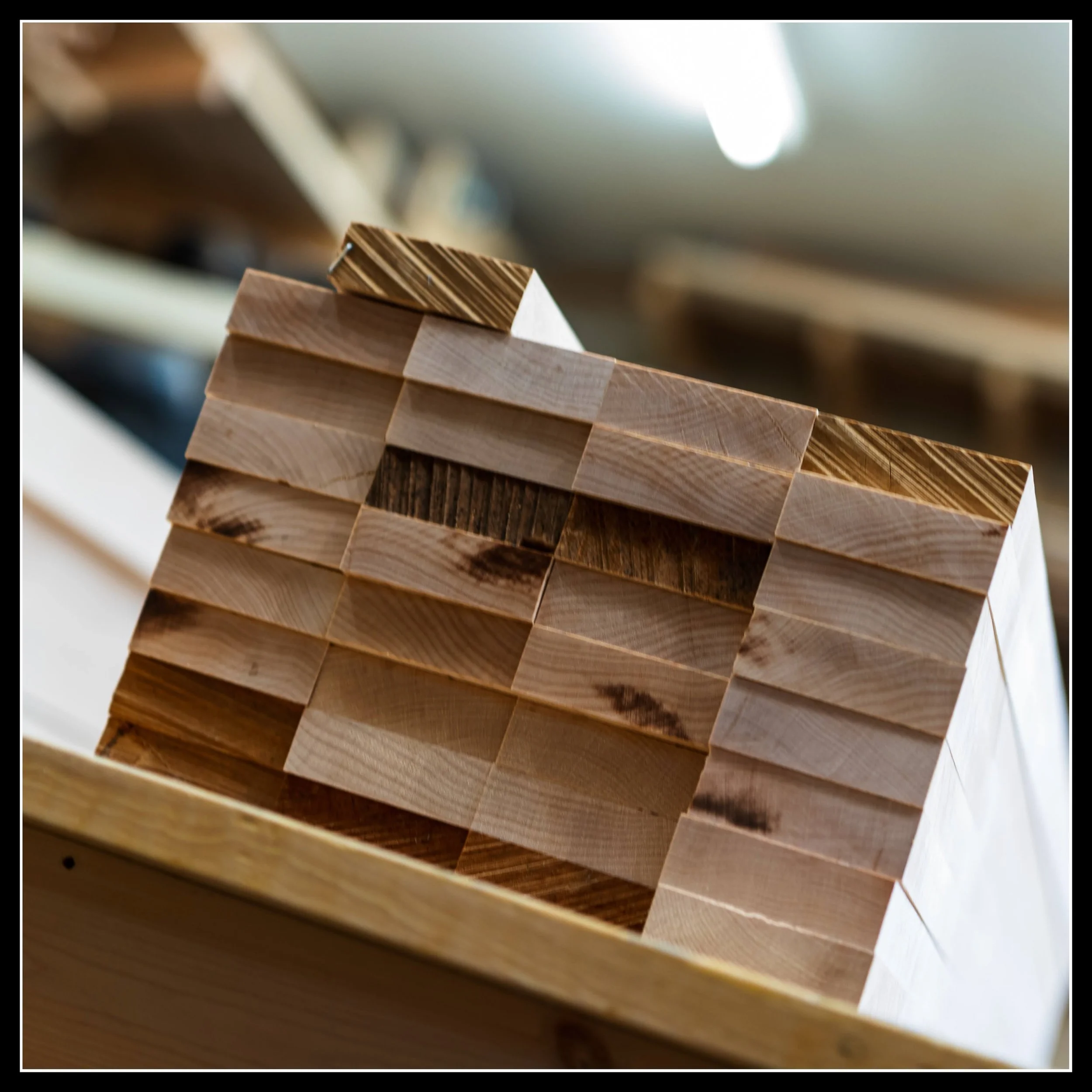 Stacked maple pieces symbolizing the future hearth room — a metaphor for the warmth, craft, and hope still waiting to be built.