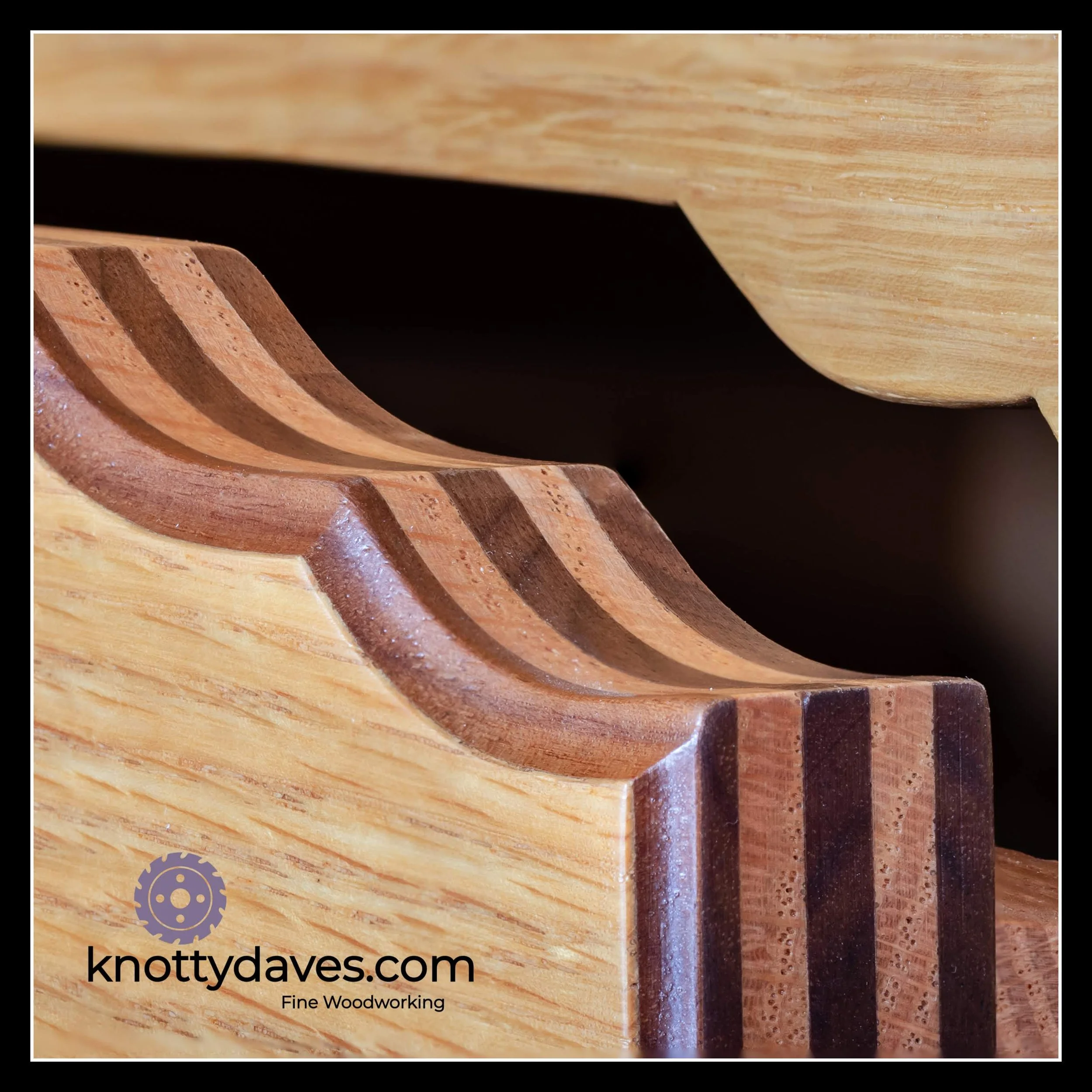 Red oak and walnut bent‑lamination drawer front with curved profile and clear finish showing layered hardwood detail.