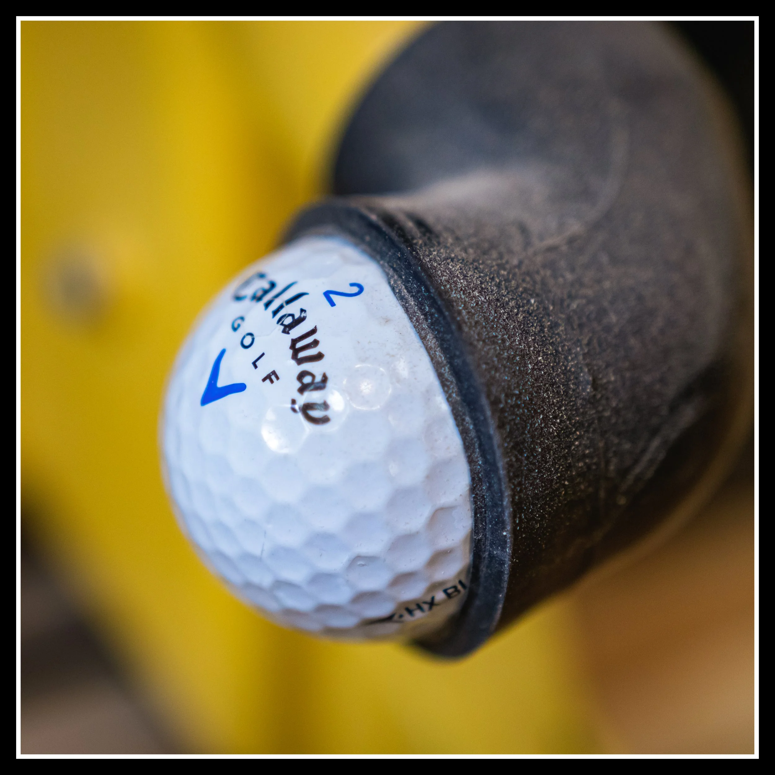 Dust‑extraction port on DeWalt radial arm saw guard plugged with a golf ball, showing ineffective factory dust design for cross‑cutting.