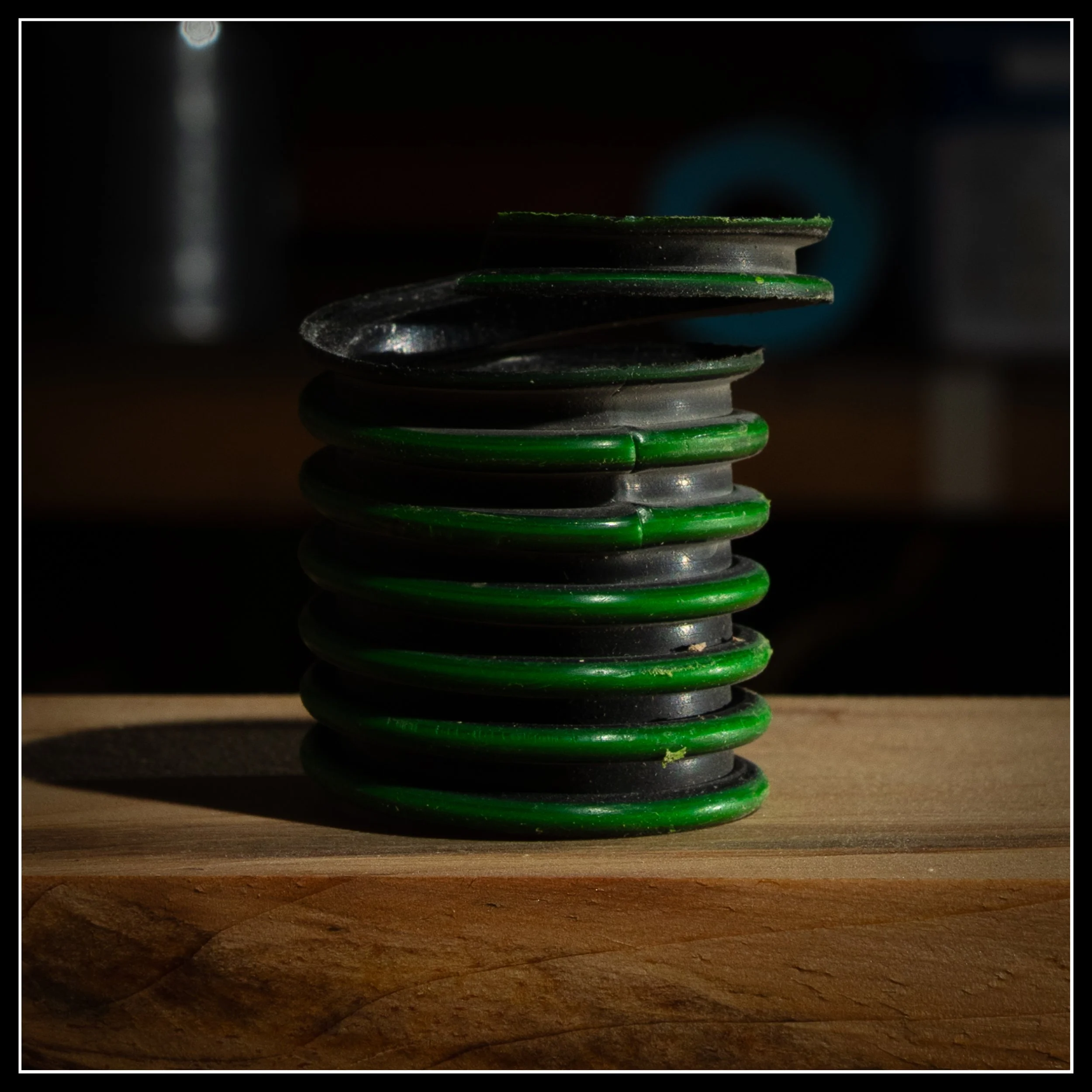 Green replacement hose coil from a Festool Midi dust extractor, representing the small unseen repairs that keep a woodworking shop running.