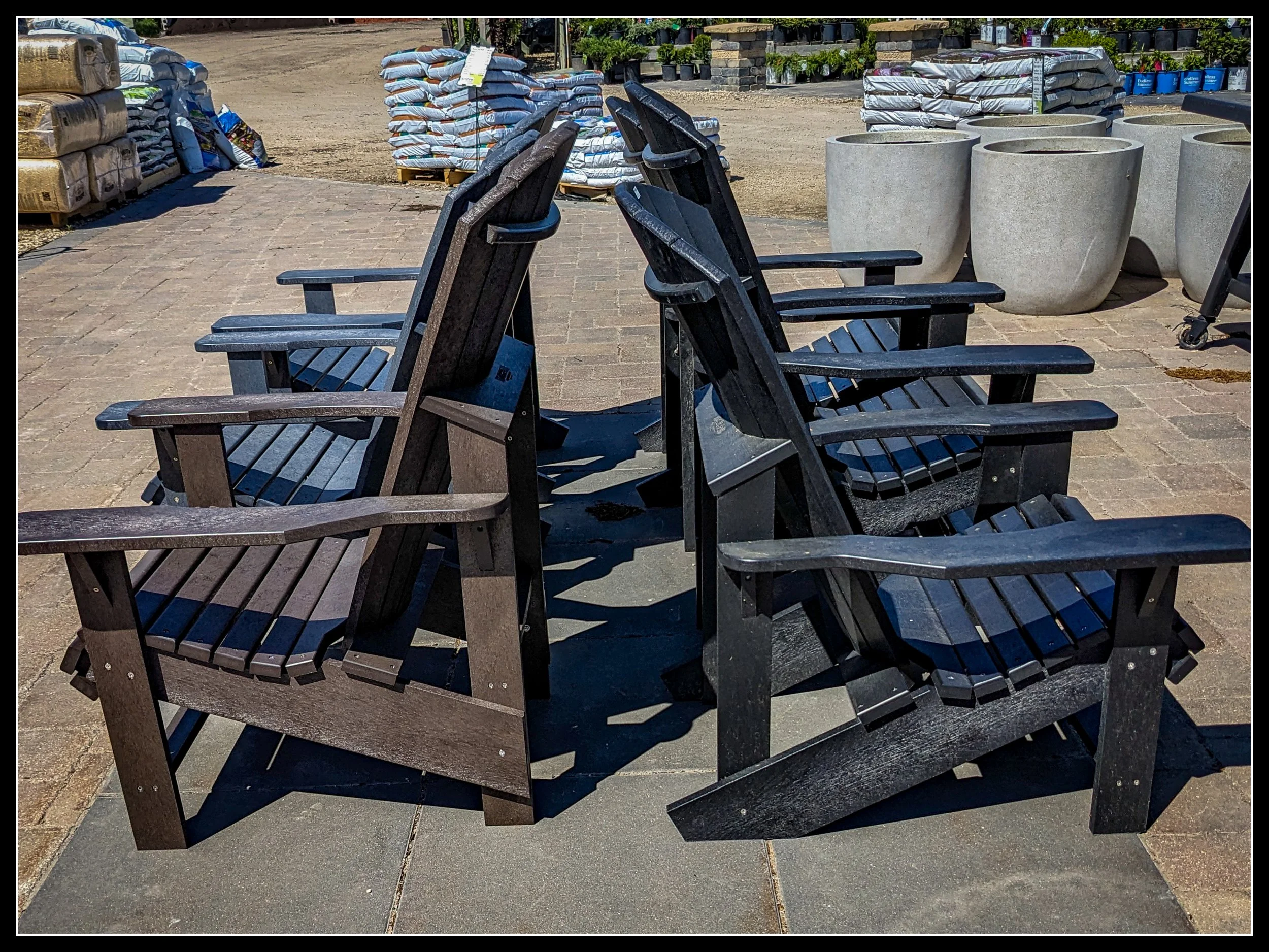 HDPE Muskoka chairs for sale at a Steinbach greenhouse, heavy plastic furniture designed as a modern alternative to cedar.