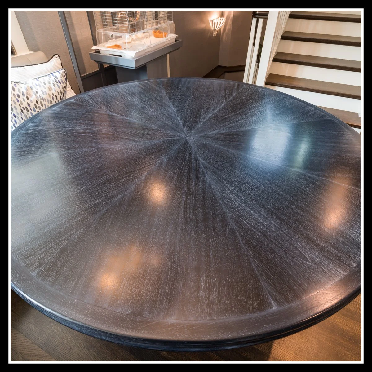 60‑inch round rift‑cut walnut breakfast table with starburst veneer pattern, bent‑laminated solid walnut edge, and stain‑glaze‑2K poly finish.