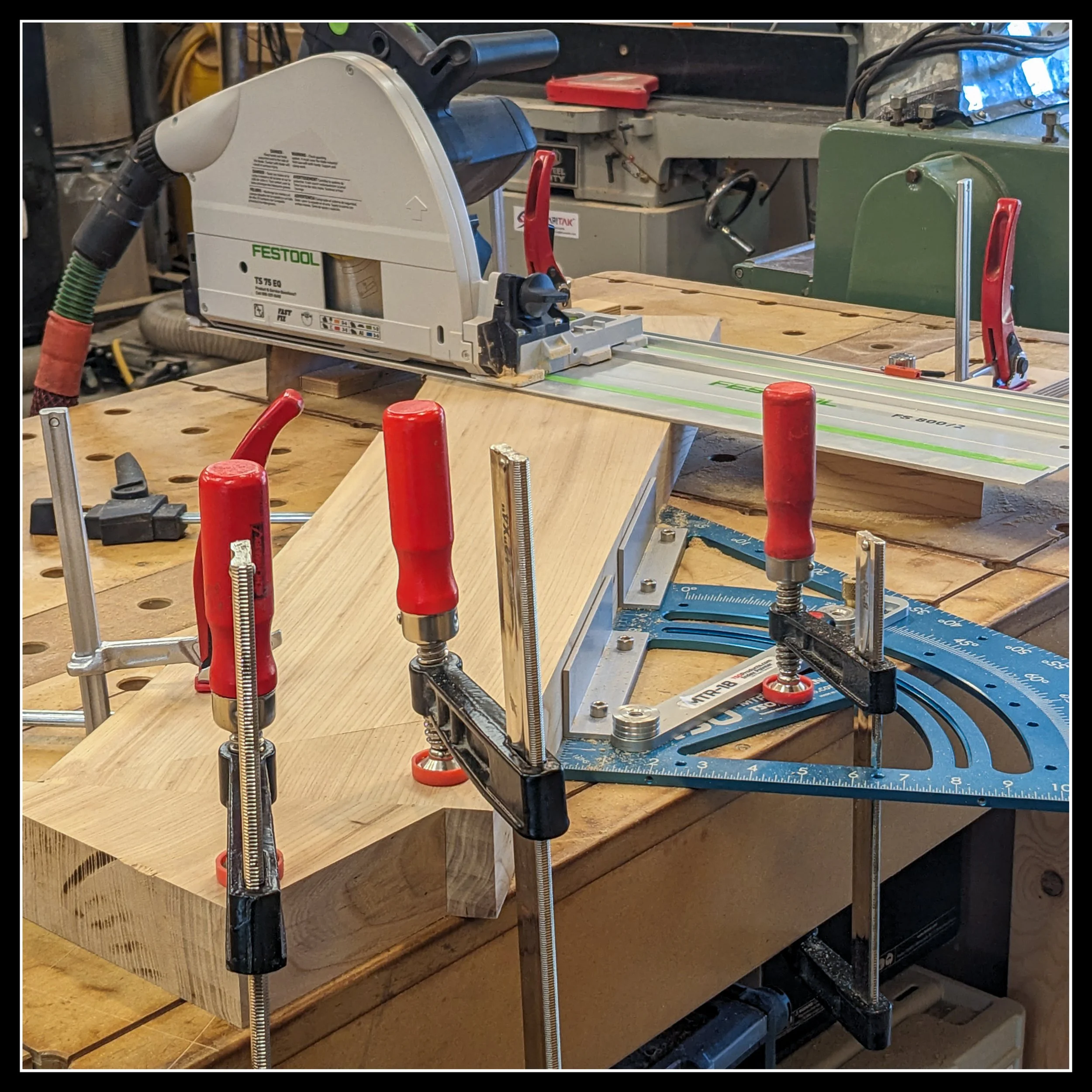 Angle‑cutting jig mounted on an MFT bench with Festool rail, clamps, and guides, showing a precise setup for accurate repeatable angled cuts.