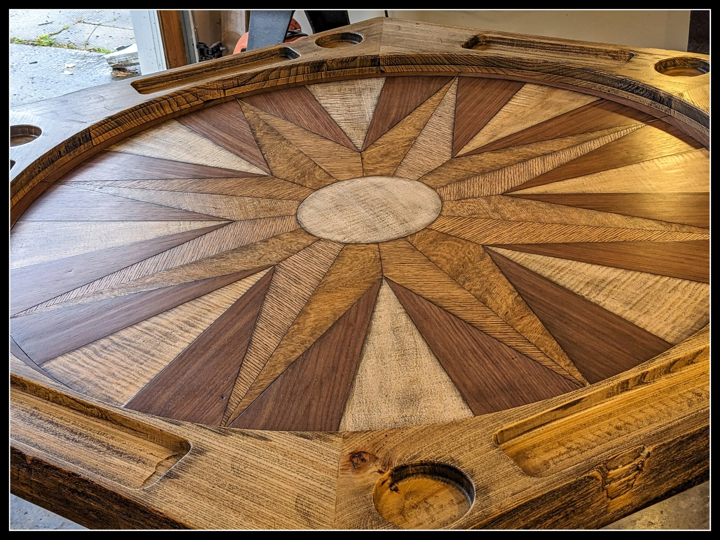 Games table with solid elm racetrack and starburst veneer in maple, walnut, red oak, and white oak.