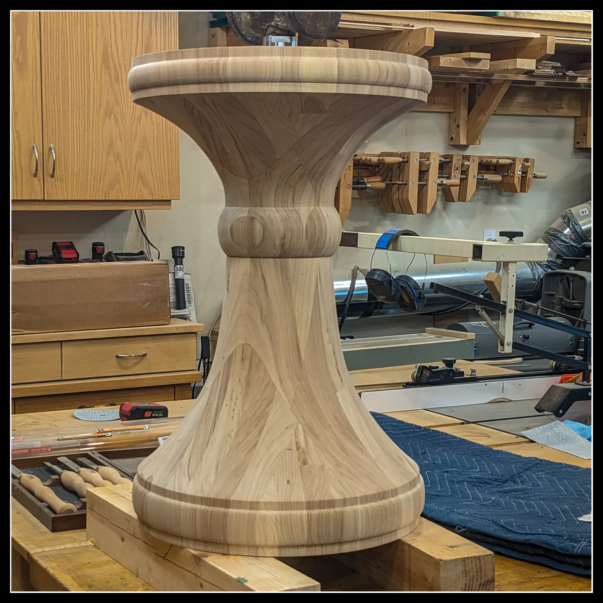 Solid elm pedestal fully assembled for a starburst games table, lathe‑turned with smooth curves and hardwood grain.