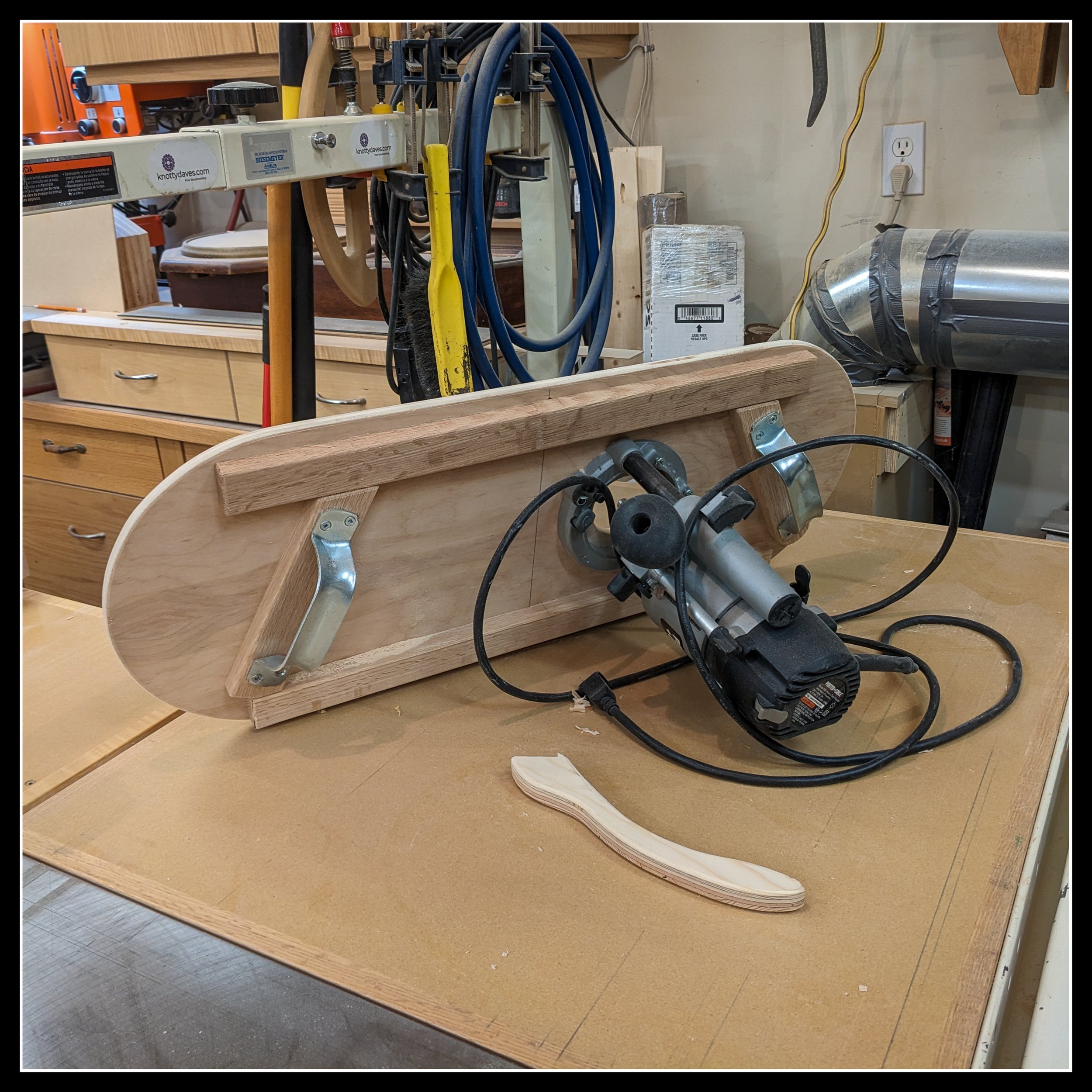 Custom router sled jig built for large router bits, designed to provide safe, controlled cutting in a woodworking shop.